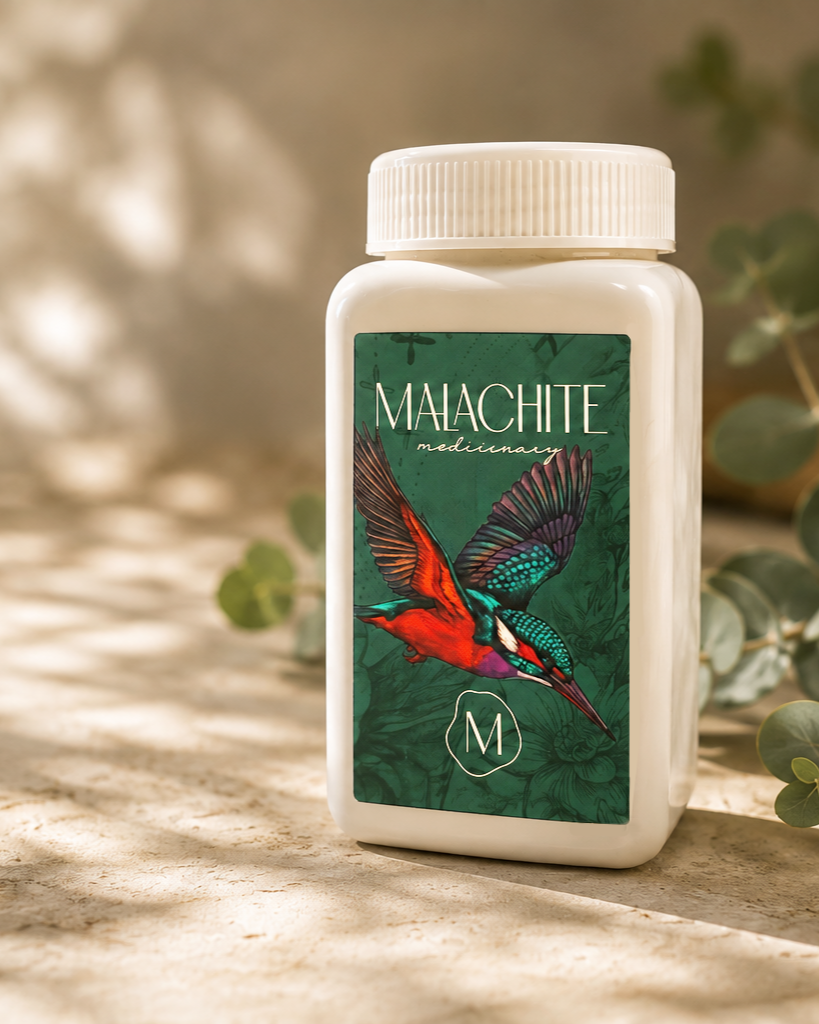 A white bottle labeled 'Malachite Medicinary' features a colorful illustration of a hummingbird on a green background with leafy patterns.
