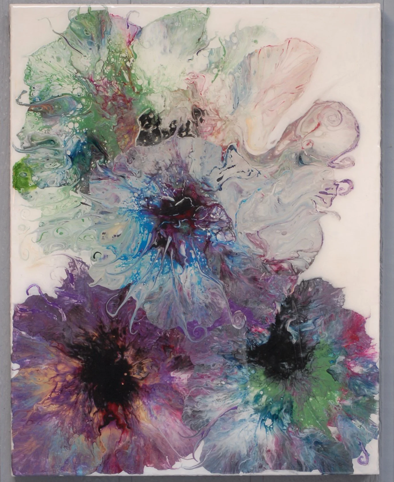 Abstract colorful painting with hues of green, purple, pink, blue, and black, featuring fluid, swirling patterns and splashes of color.