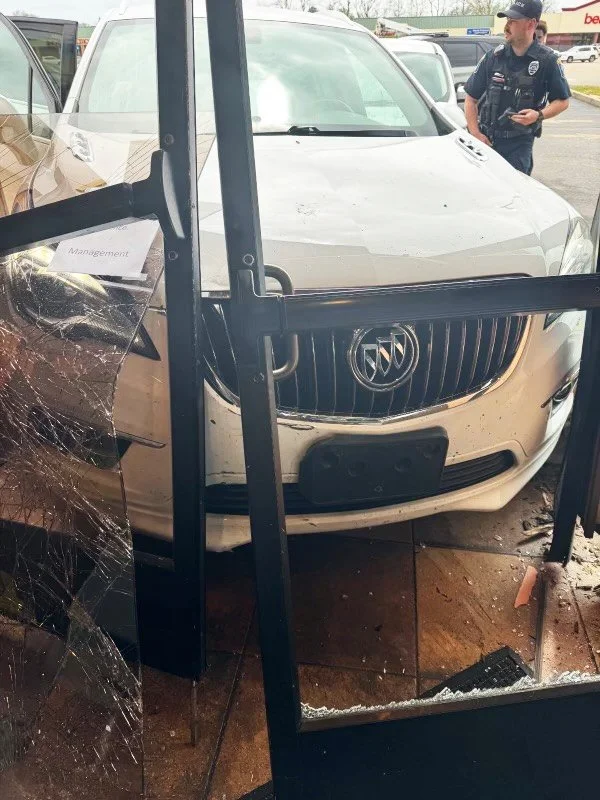 White SUV crashed into a glass display window, shattered, before The Board Up Company stabilized the structure.