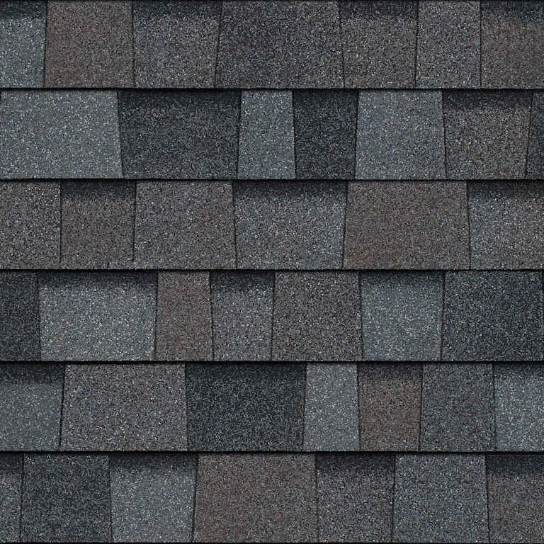 Close-up of dark gray asphalt shingles on a roof.
