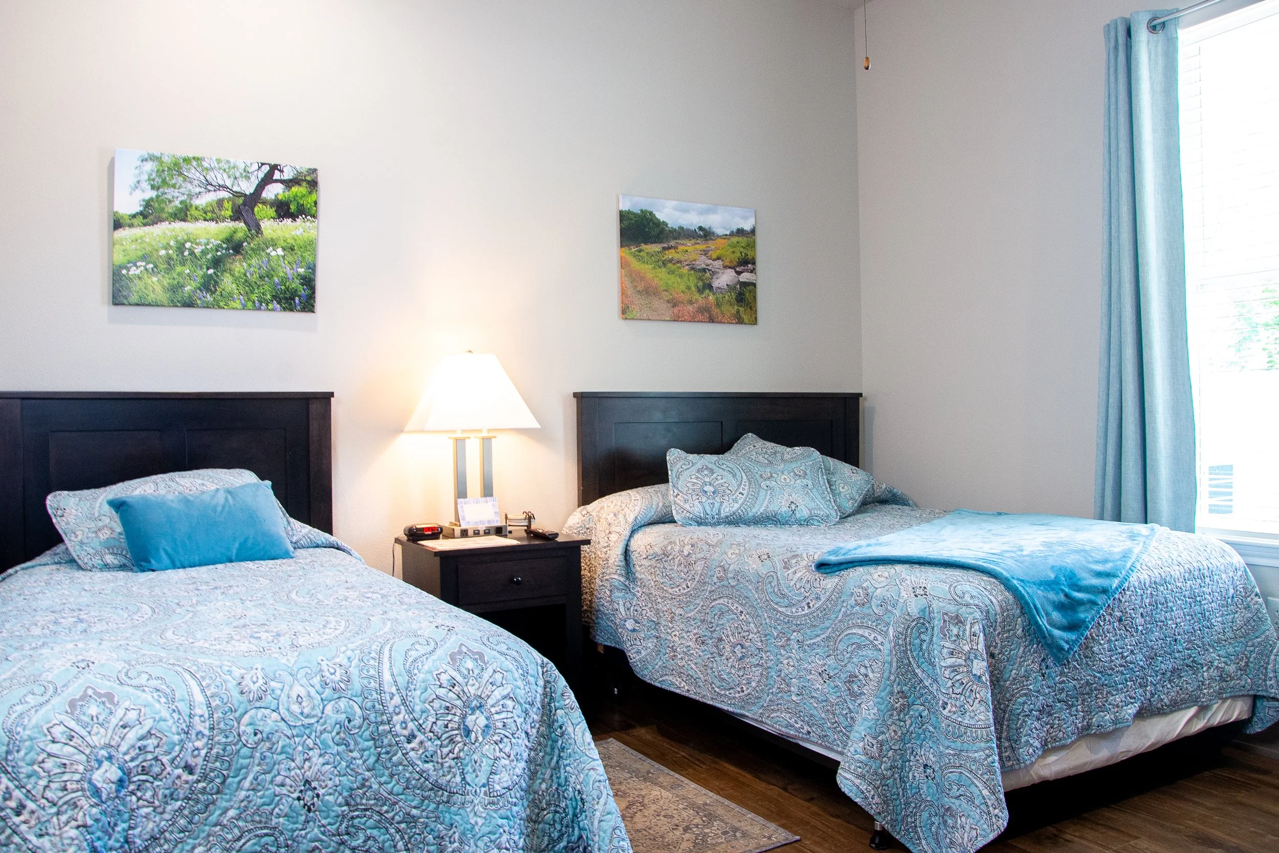Bedroom with two beds fully made