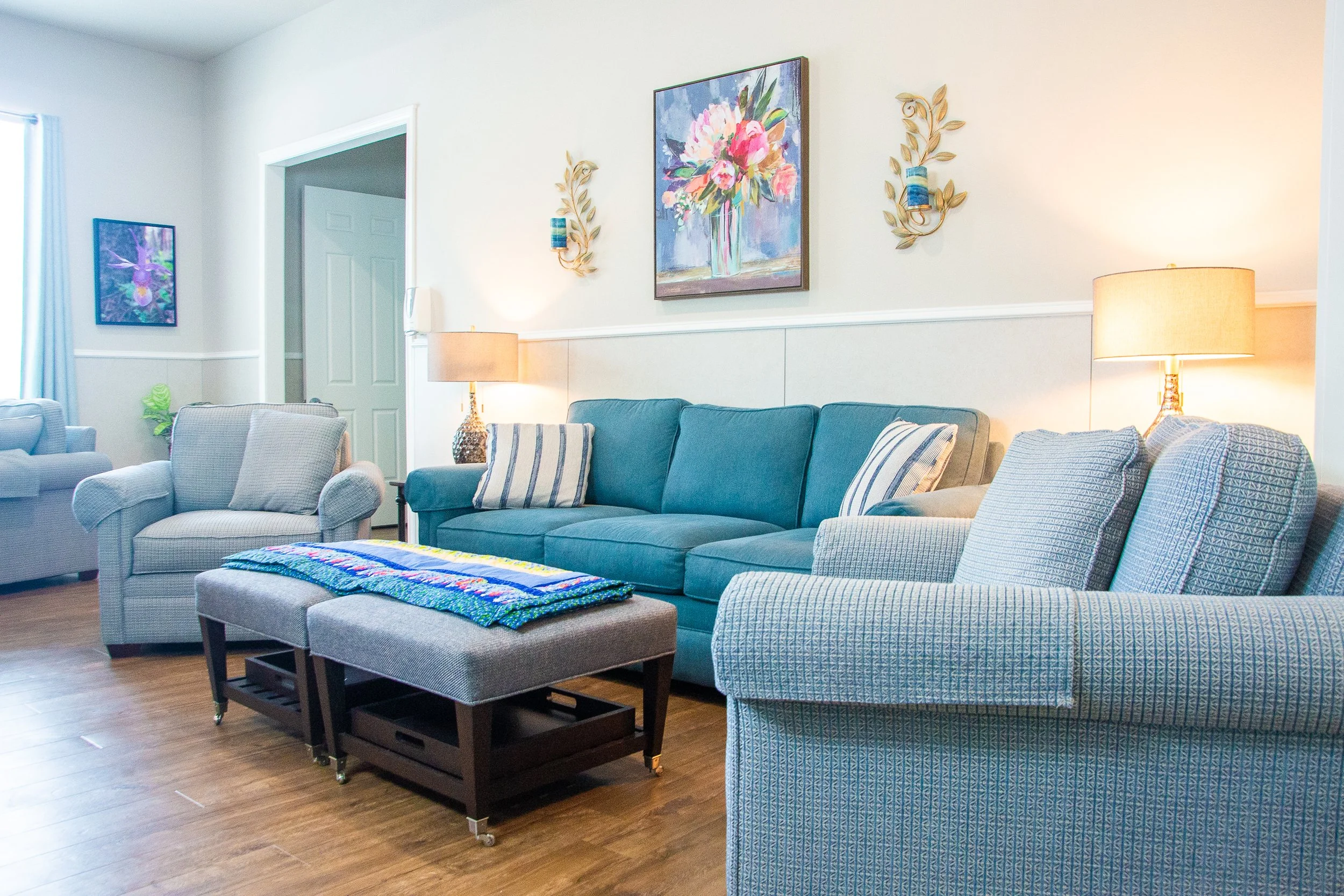 Living room area with light blue couches and chairs
