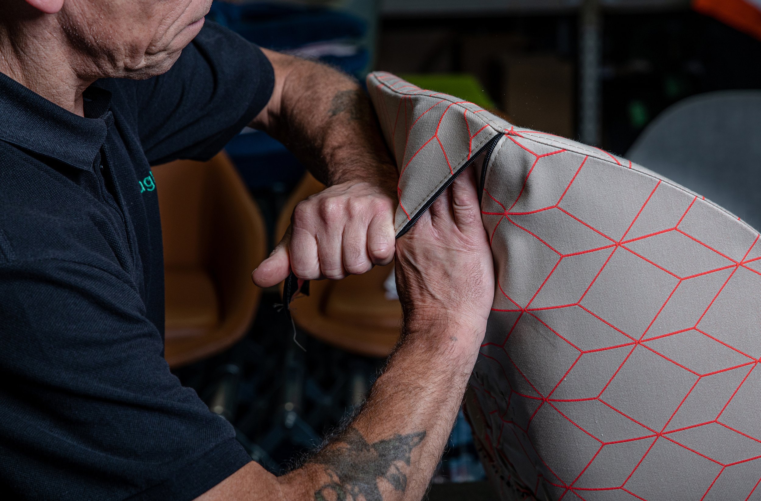 Man is covering a chair in new upholstery