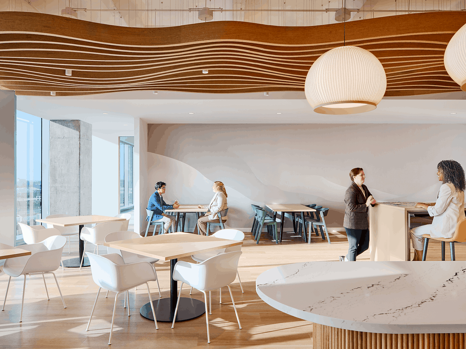 employees in an office cafe collaborating and chatting