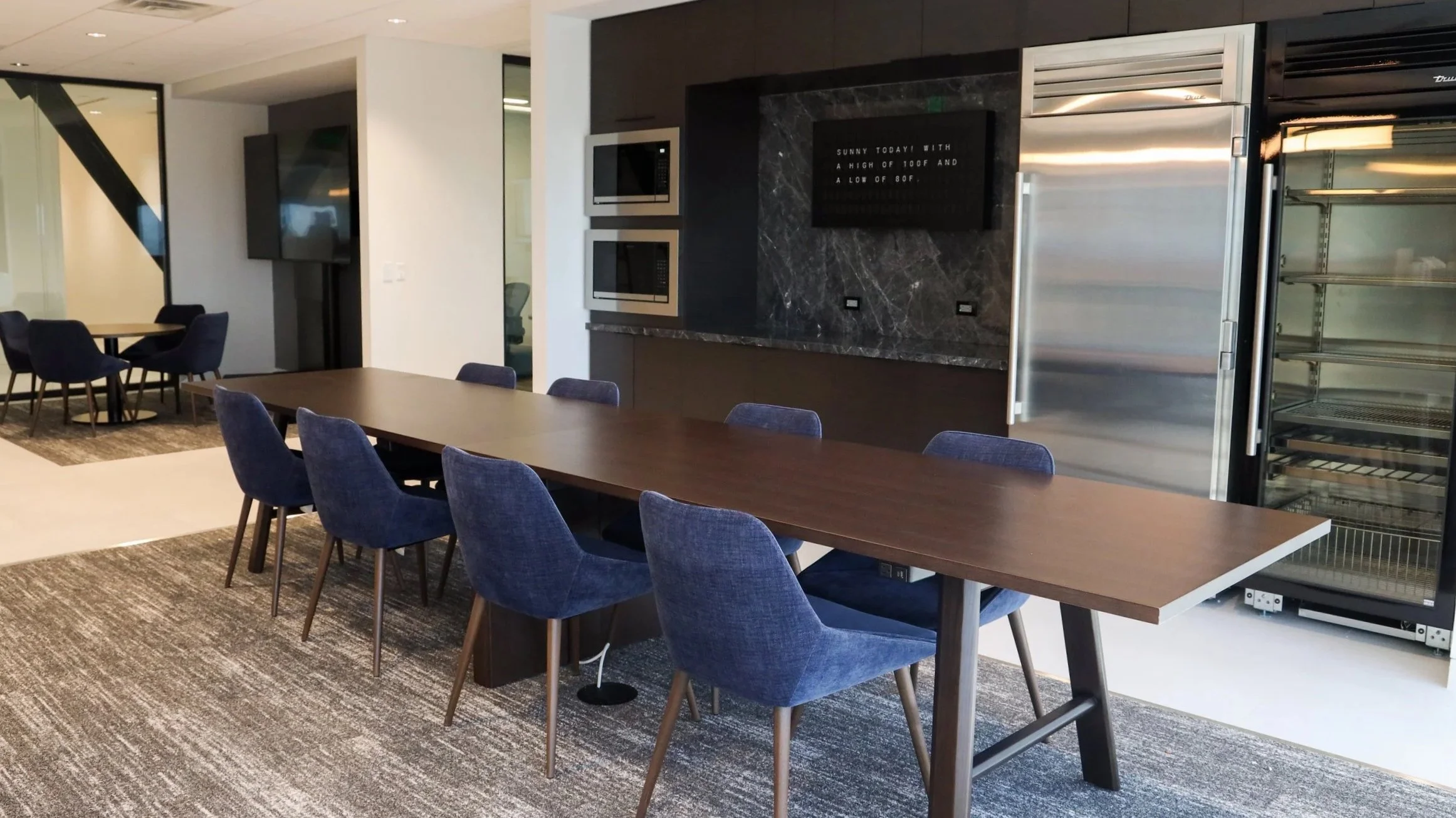 Break room with wooden tables and blue chairs