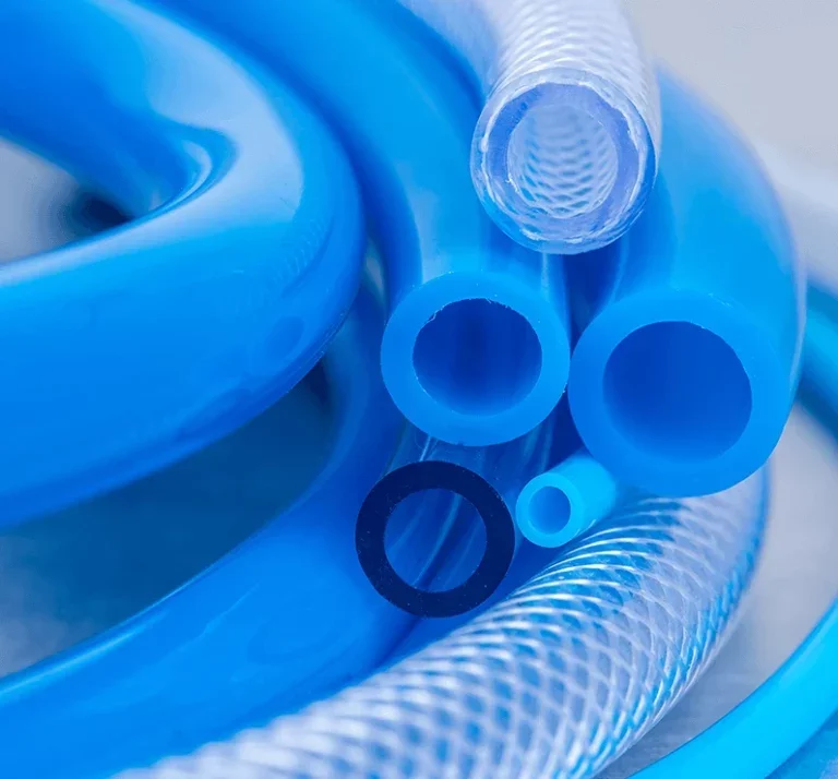 Close-up of various blue and transparent plastic tubing coils and hollow cylinders.