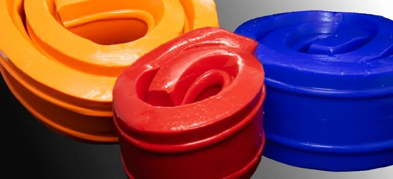 Close-up of colorful plastic rope coils in orange, red, and blue.