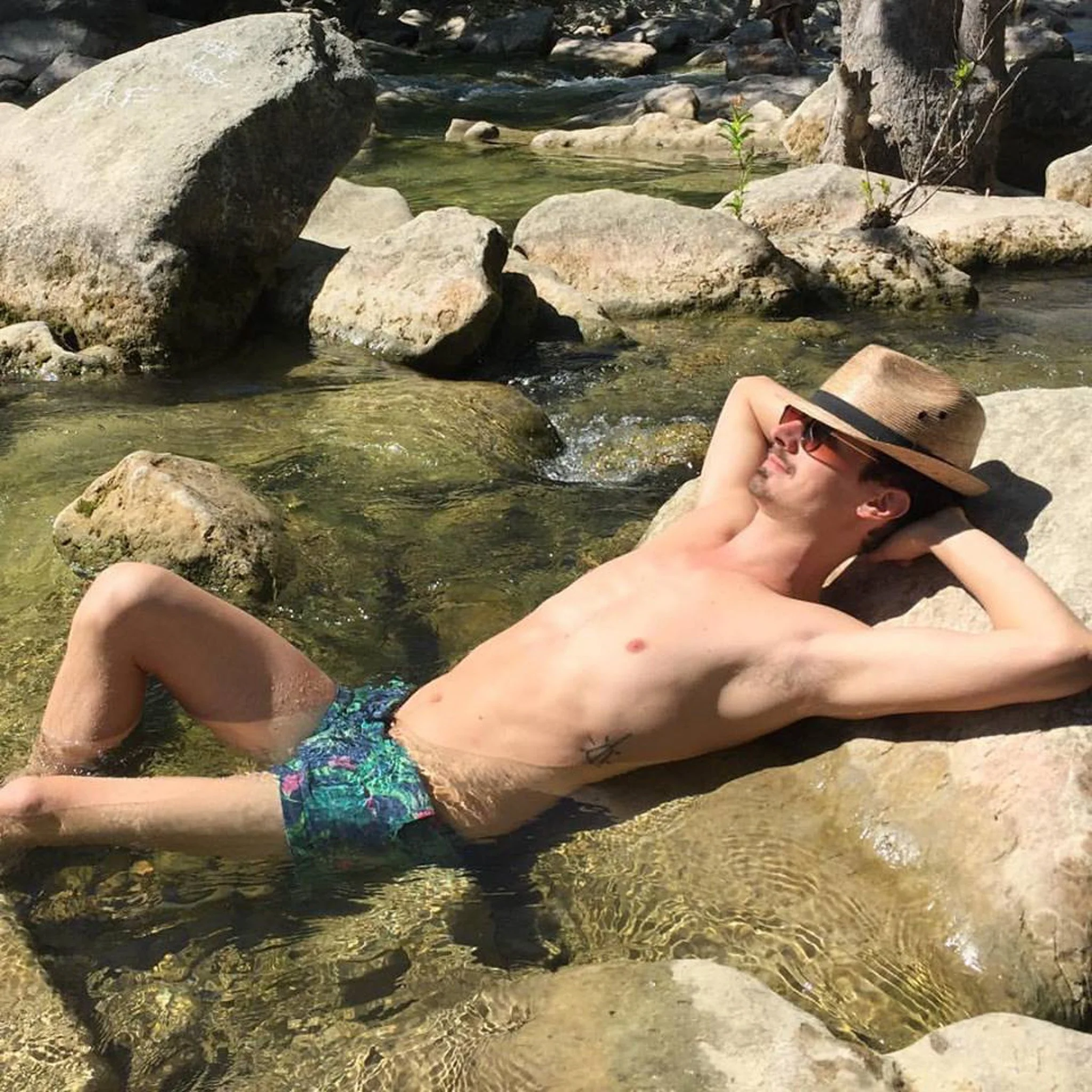 brahm laying on rocks in water.jpg