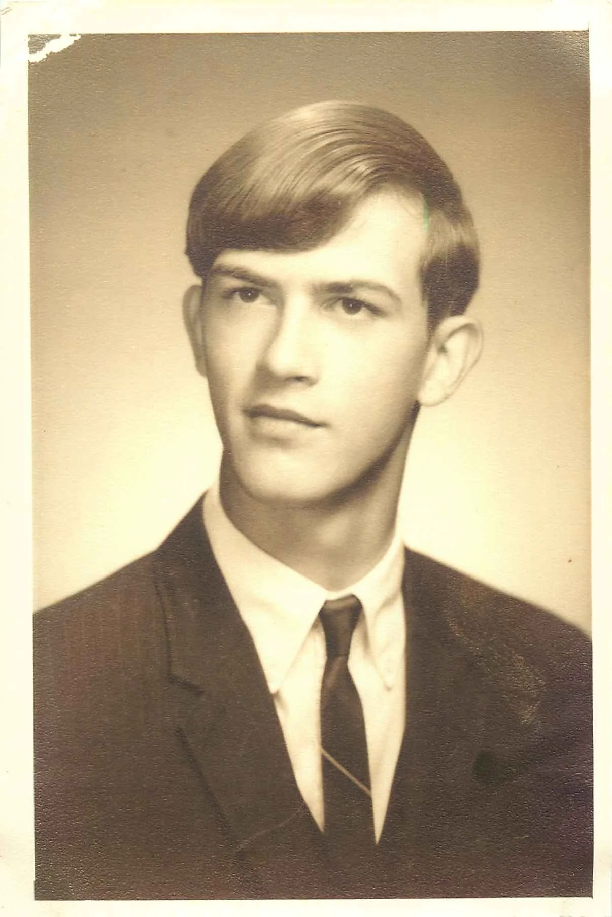 A black and white senior portrait of a young Richard (Rick) Hess in a suit and tie, with neatly combed hair, in a formal studio setting, most likely LCMRHS circa 1968.
