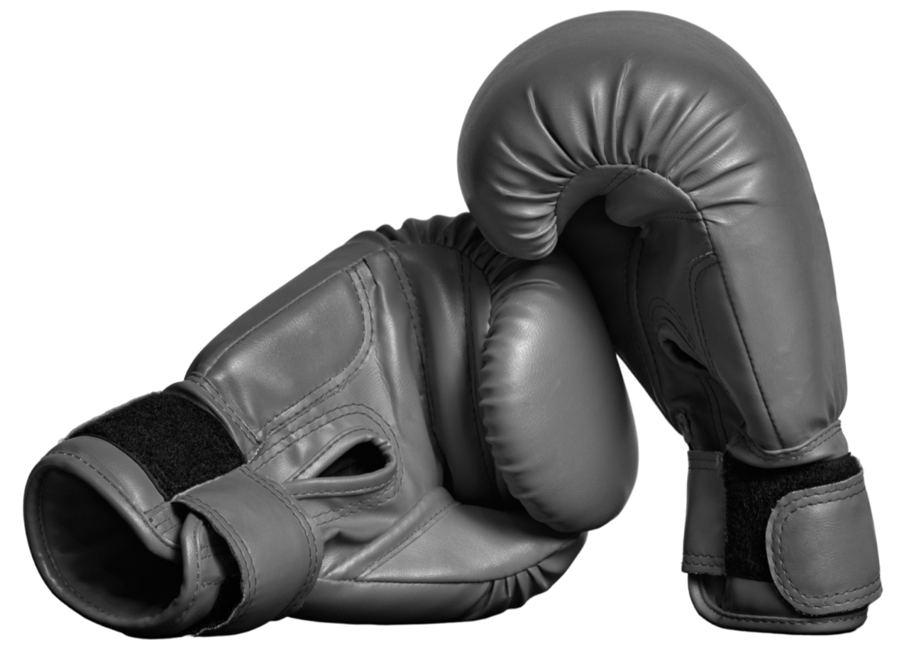 A pair of black boxing gloves, one resting on top of the other, with velcro wrist straps.