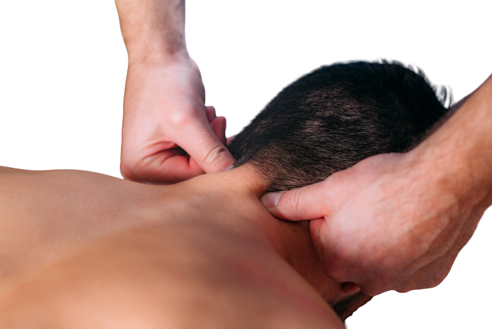 A person receiving a massage, with a focus on the upper back and neck area, while a massage therapist uses their hands to apply pressure.