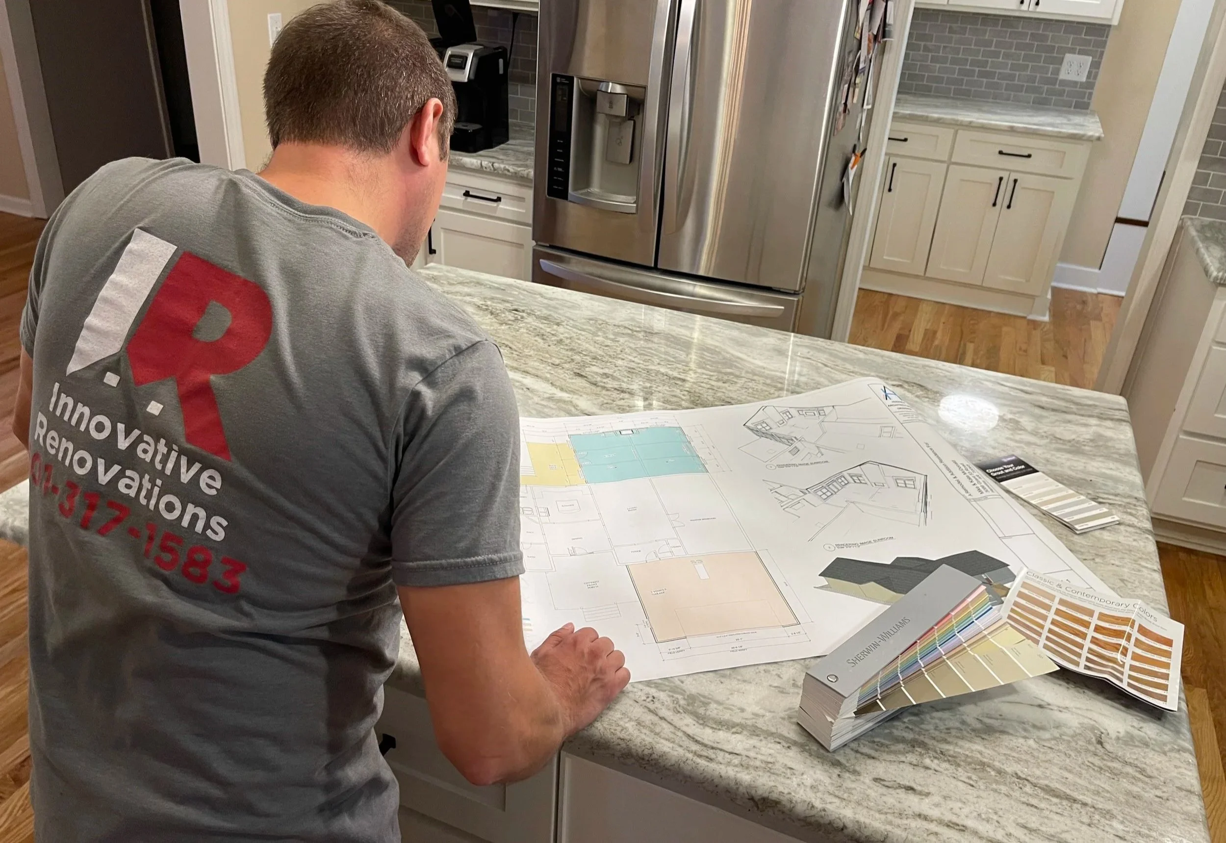 Justin Morrella, owner, looking at architectural documents for a build