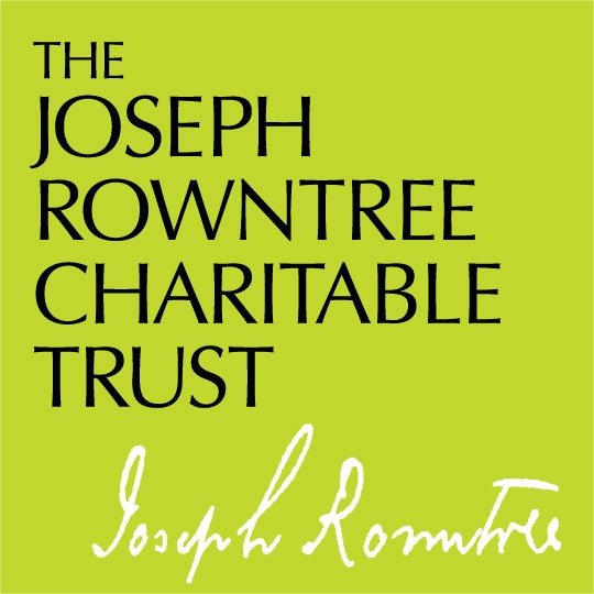 Green background with black text that reads "The Joseph Rowntree Charitable Trust" and a white handwritten signature of Joseph Rowntree.