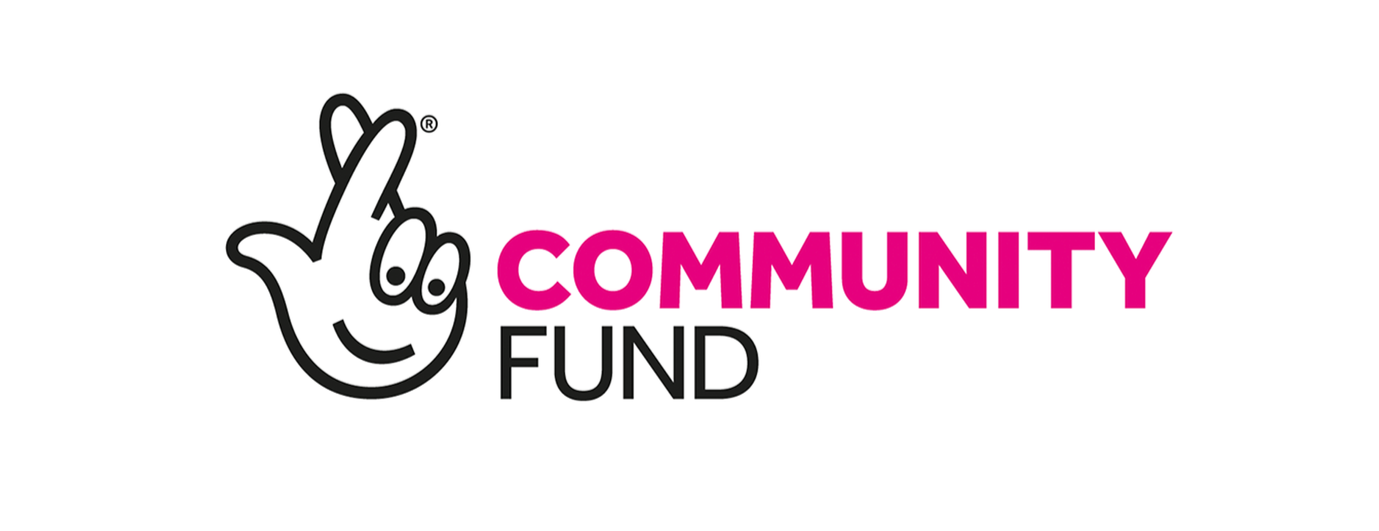 The logo of a community fund featuring a black and white hand making a finger heart gesture, with the words 'COMMUNITY FUND' in bold pink and black letters.