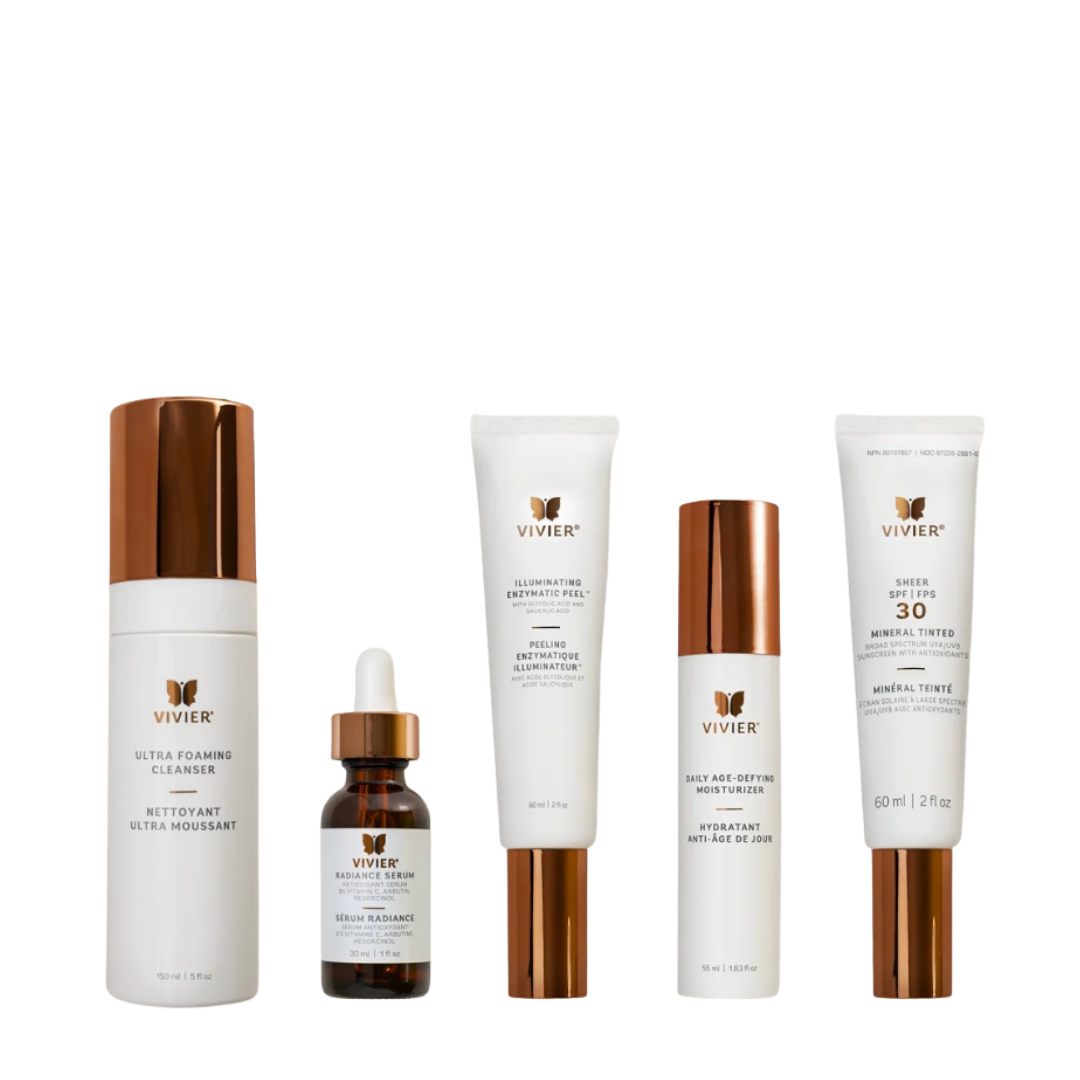 Collection of skincare products including a cleanser, serum, night moisturizer, brightening peel, and SPF moisturizer with bronze and white packaging.