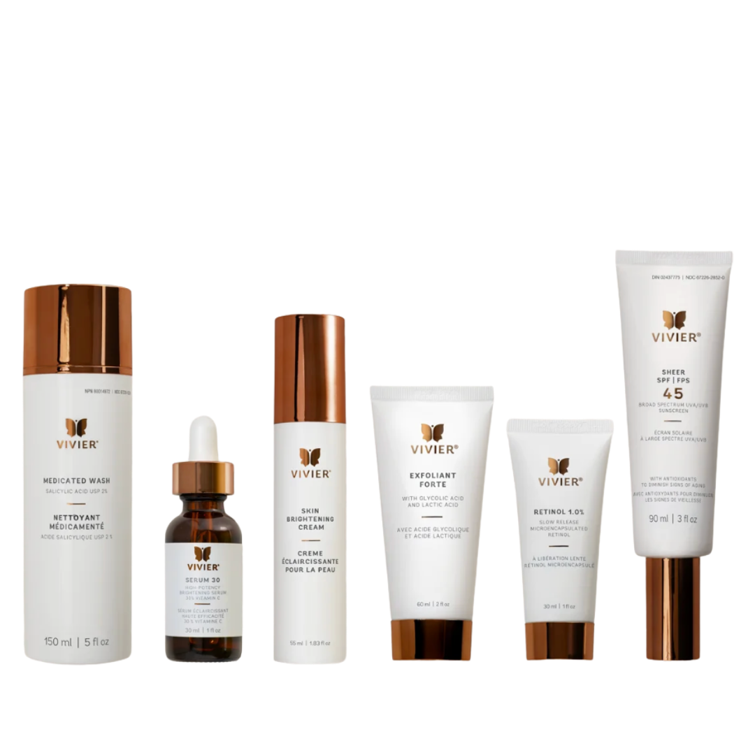 Collection of skincare products including medicated wash, serum, brightening cream, exfoliant, retinol, and sunscreen in white bottles with rose gold caps and labels.