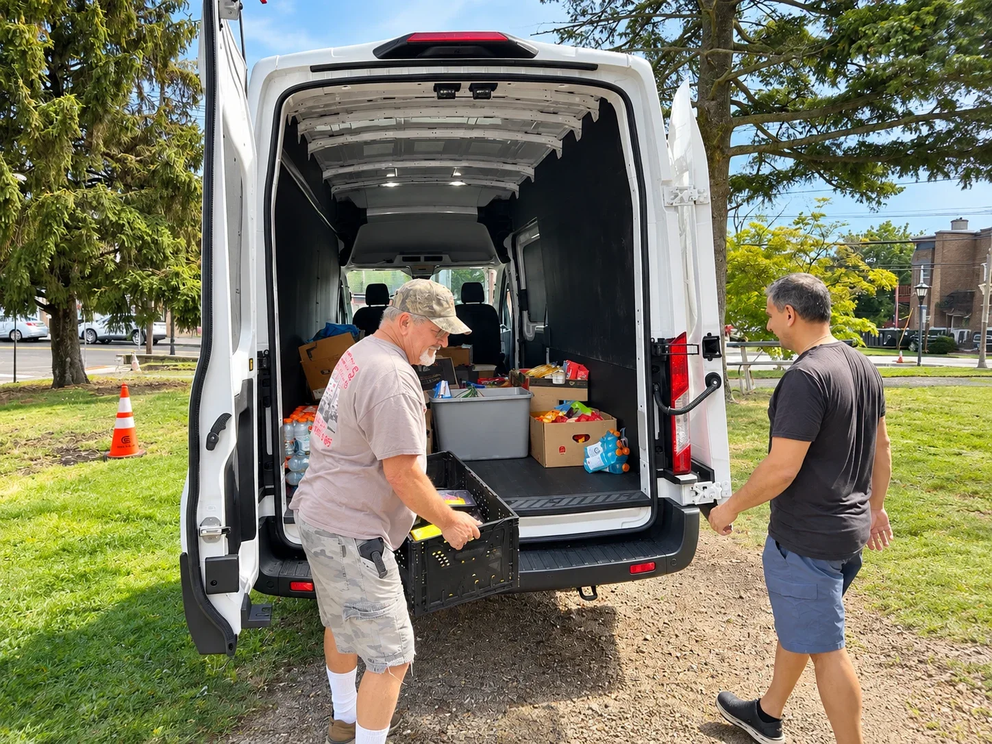 Volunteers unloading supplies for a church food delivery