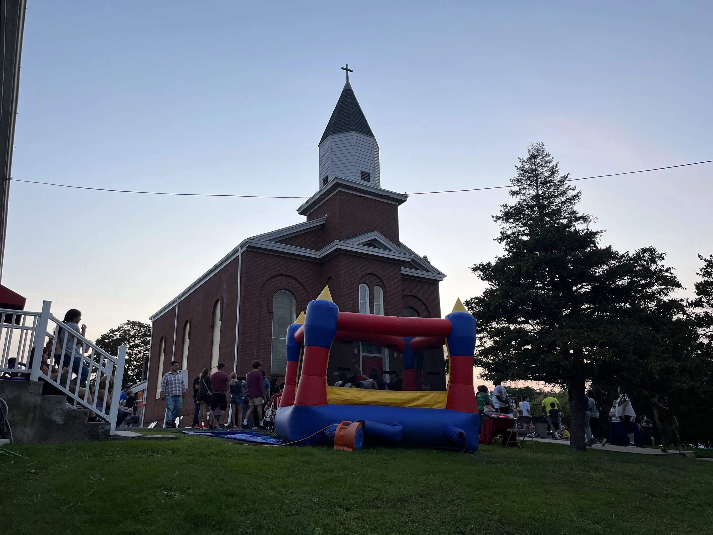 Families gather outside First Presbyterian Church of South Amboy for a community event