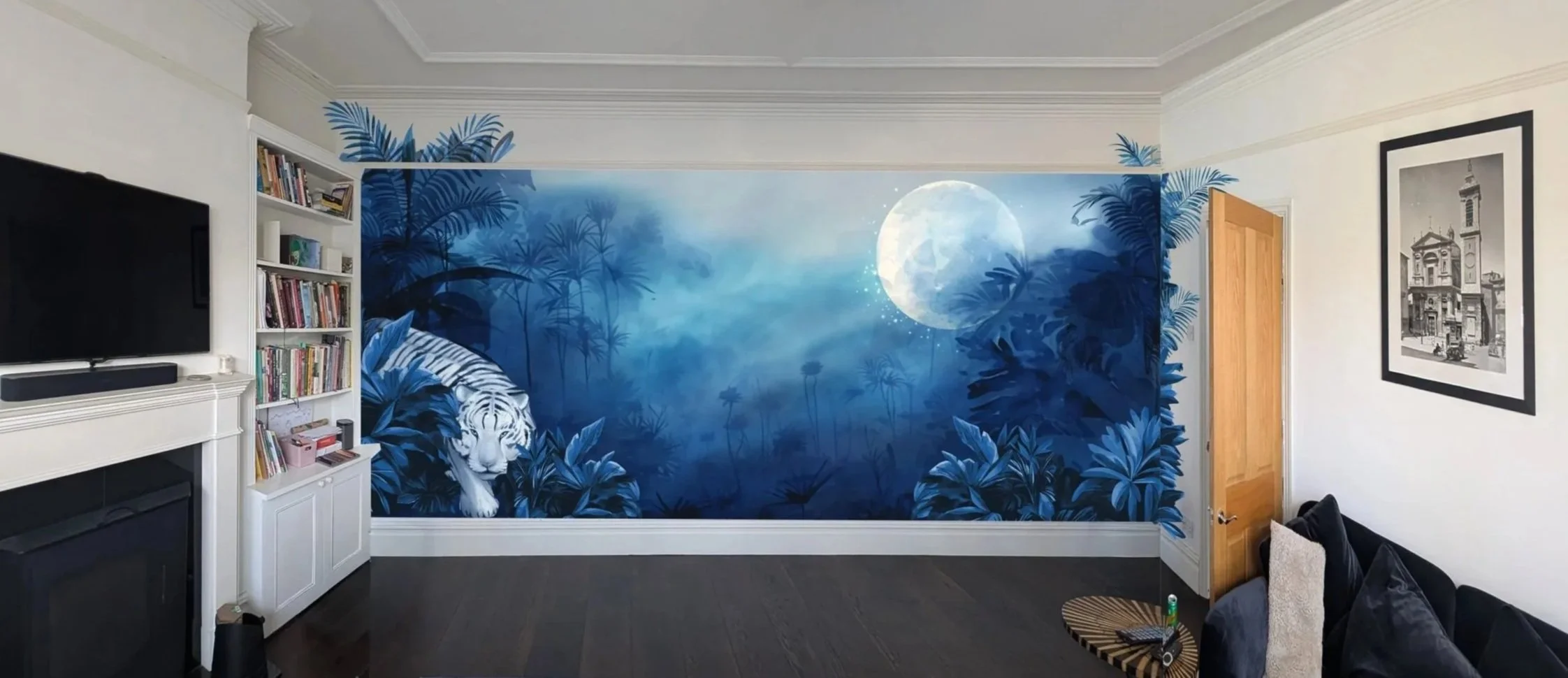 Room with a jungle-themed wall mural featuring a white tiger, blue foliage, and a bright moon sky.