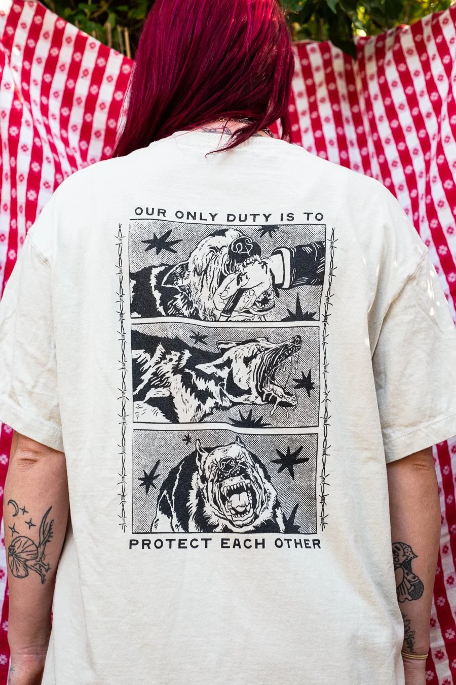 T-shirt back reads Our Only Duty is to Protect Each Other