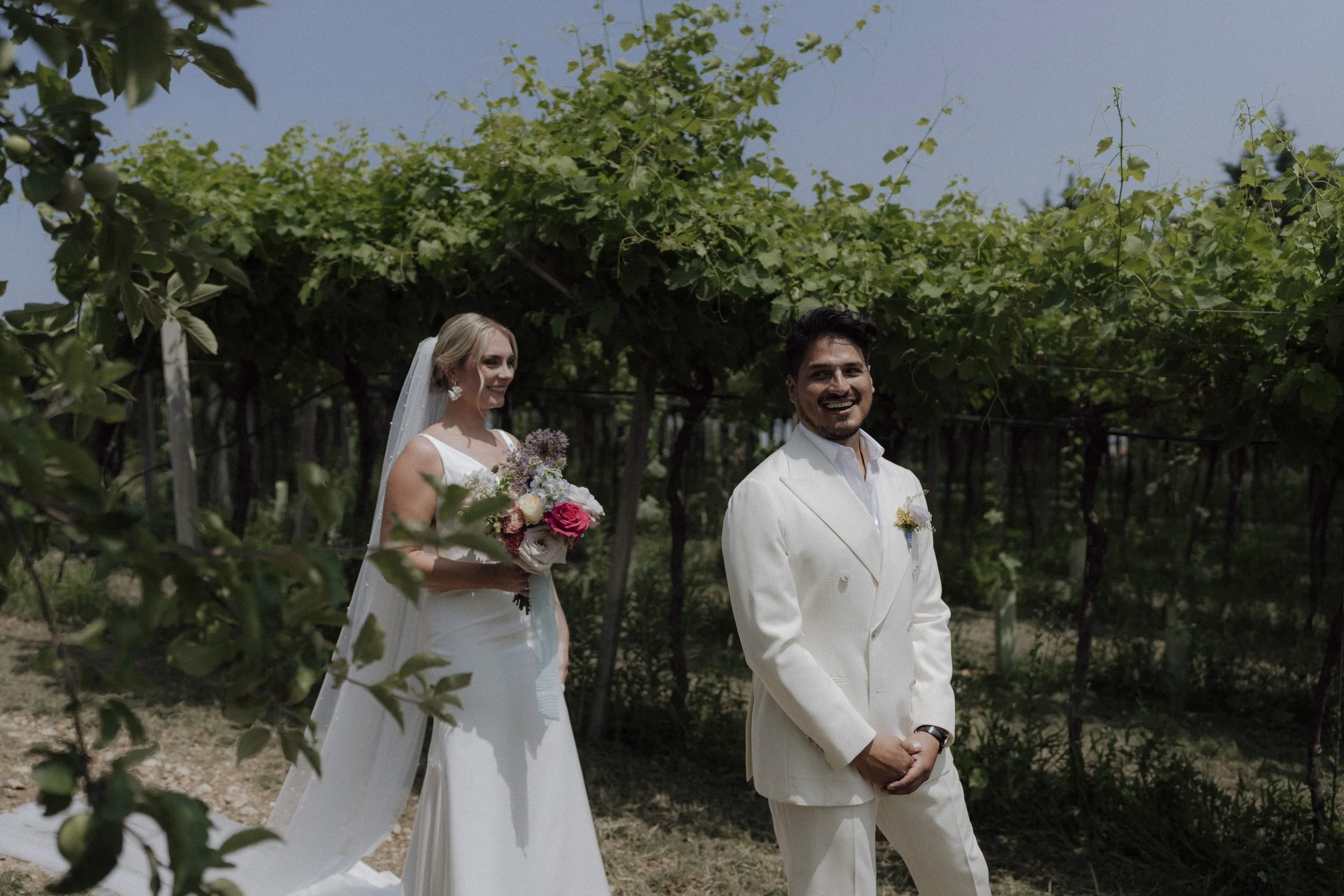 Bride and groom emotional first look among Valpolicella vineyards in Verona