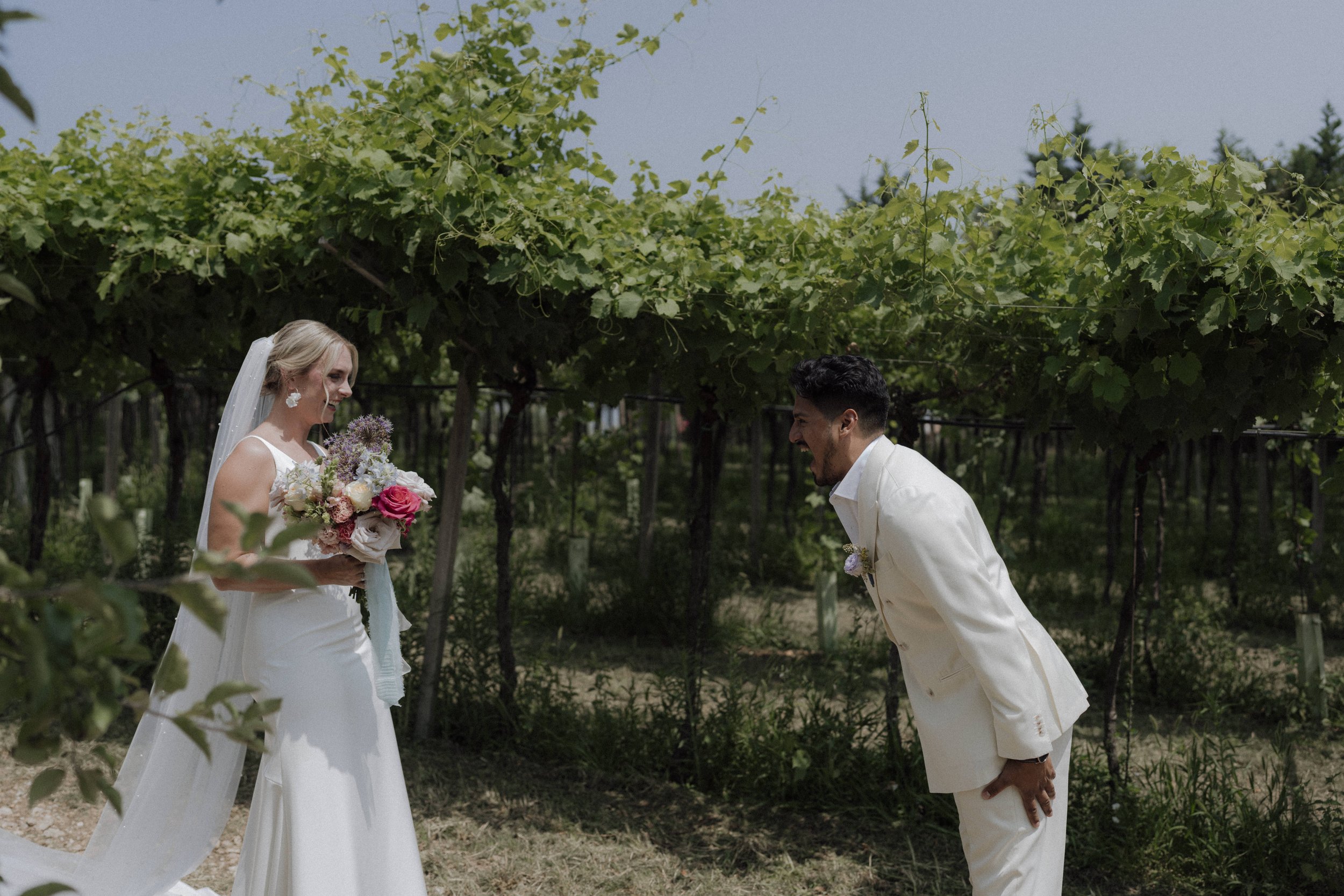 Bride and groom emotional first look among Valpolicella vineyards in Verona