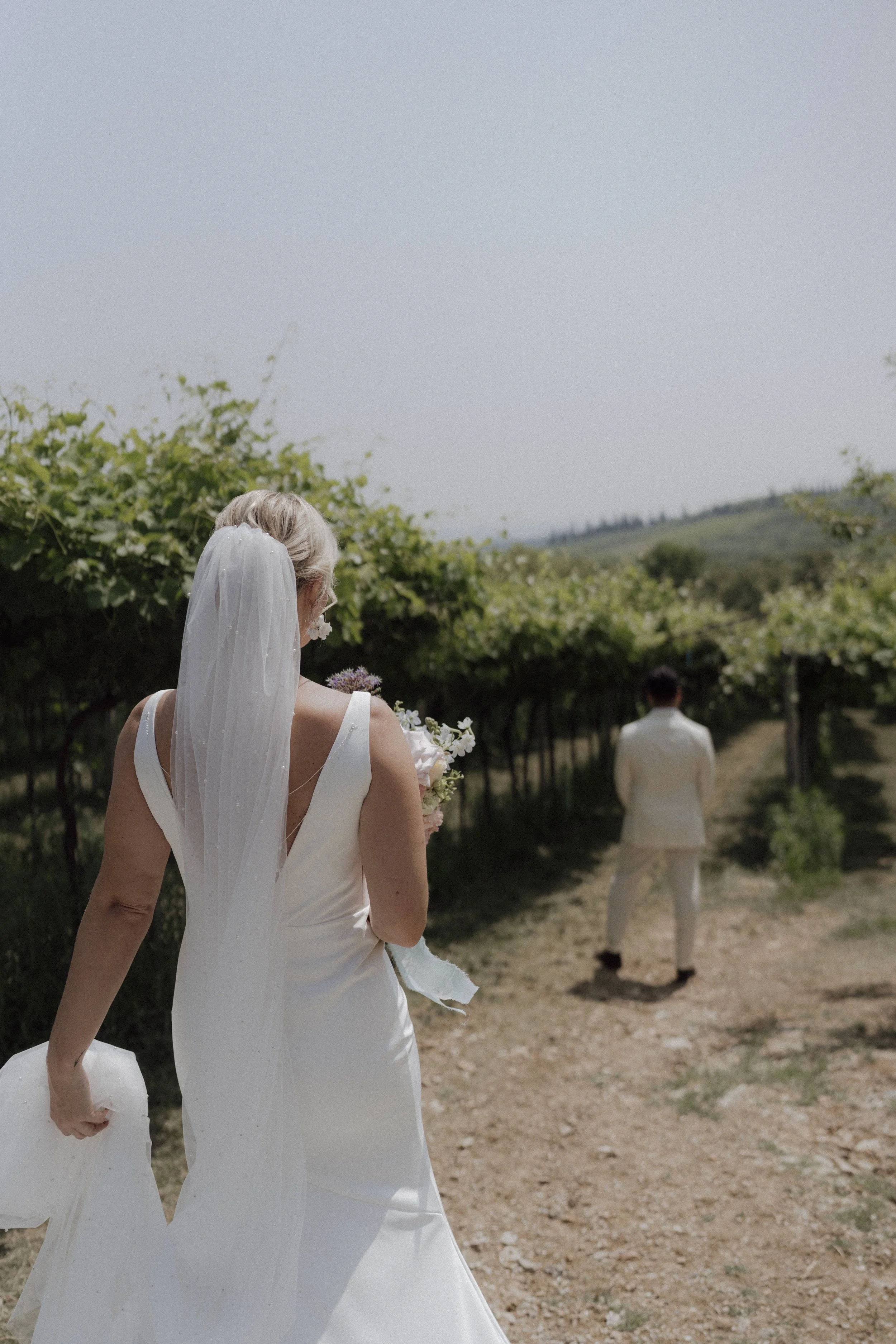 Bride and groom emotional first look among Valpolicella vineyards in Verona