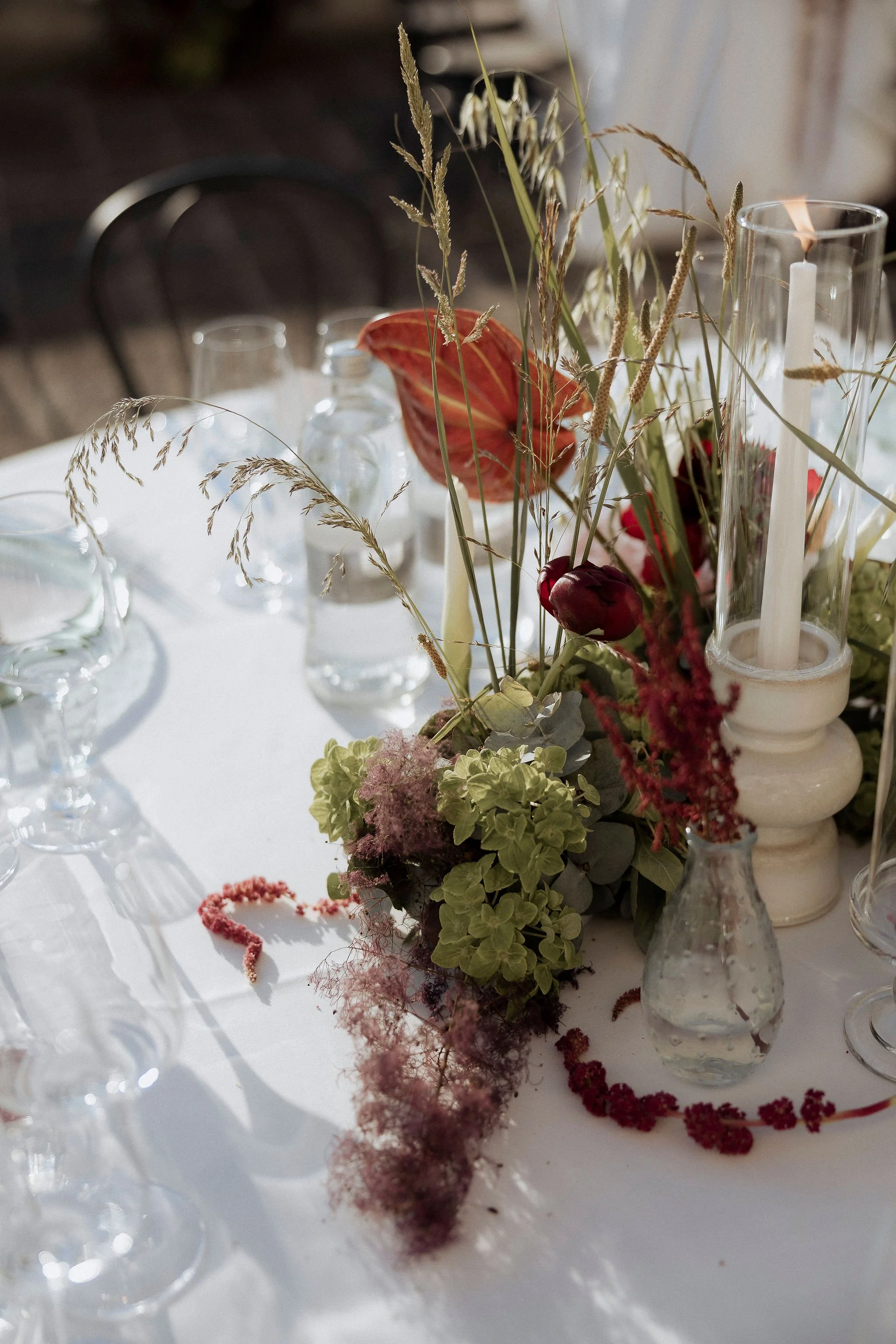 Elegant wedding table setting with olive green and burgundy details, bilingual menu, and custom stationery.