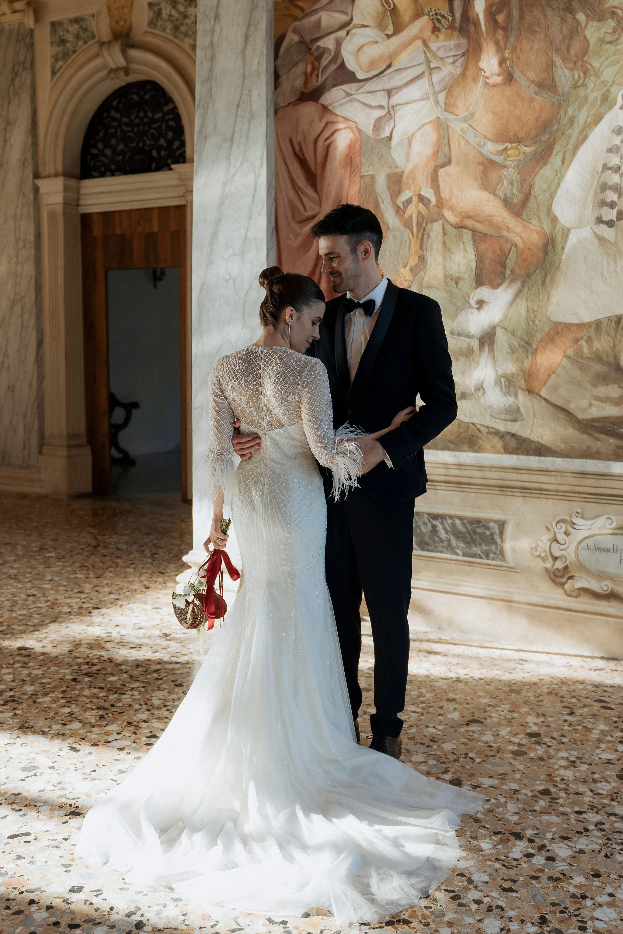 Bride and groom while posing inside Villa Selvatico