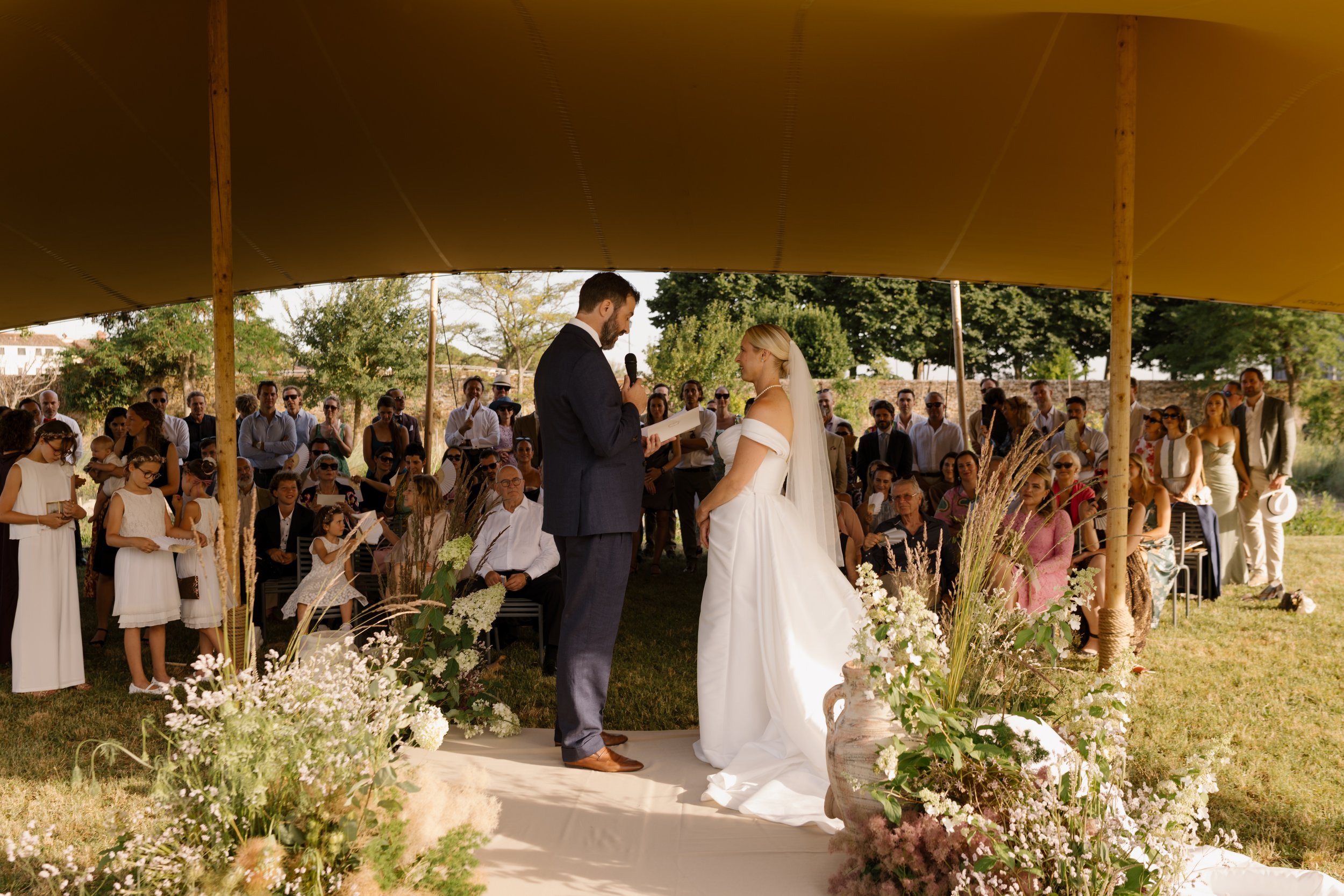 Outdoor wedding ceremony inside the walled vineyard at Venissa on Mazzorbo island, Venice.