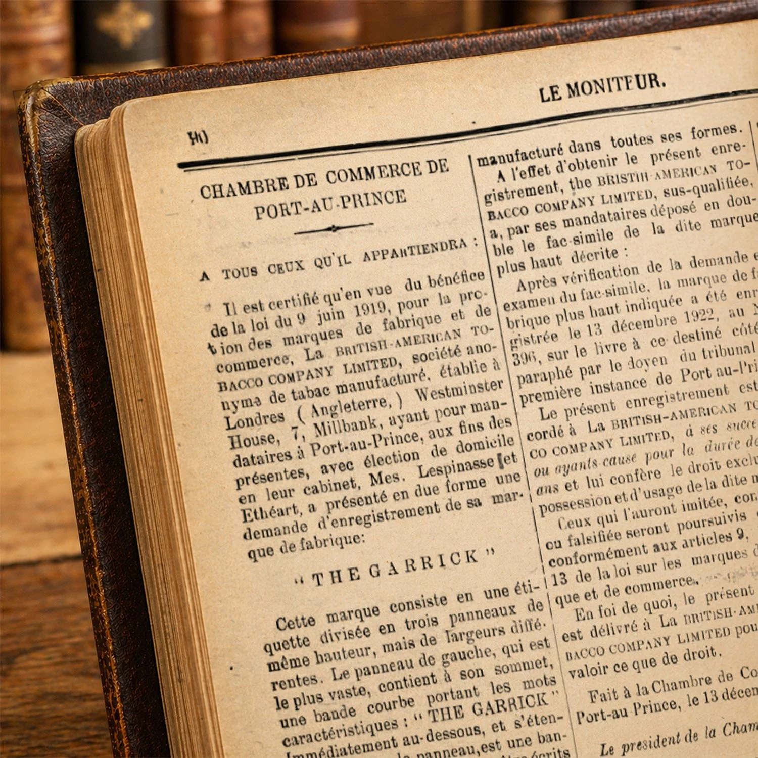 An open vintage book on a wooden surface, with French text inside.