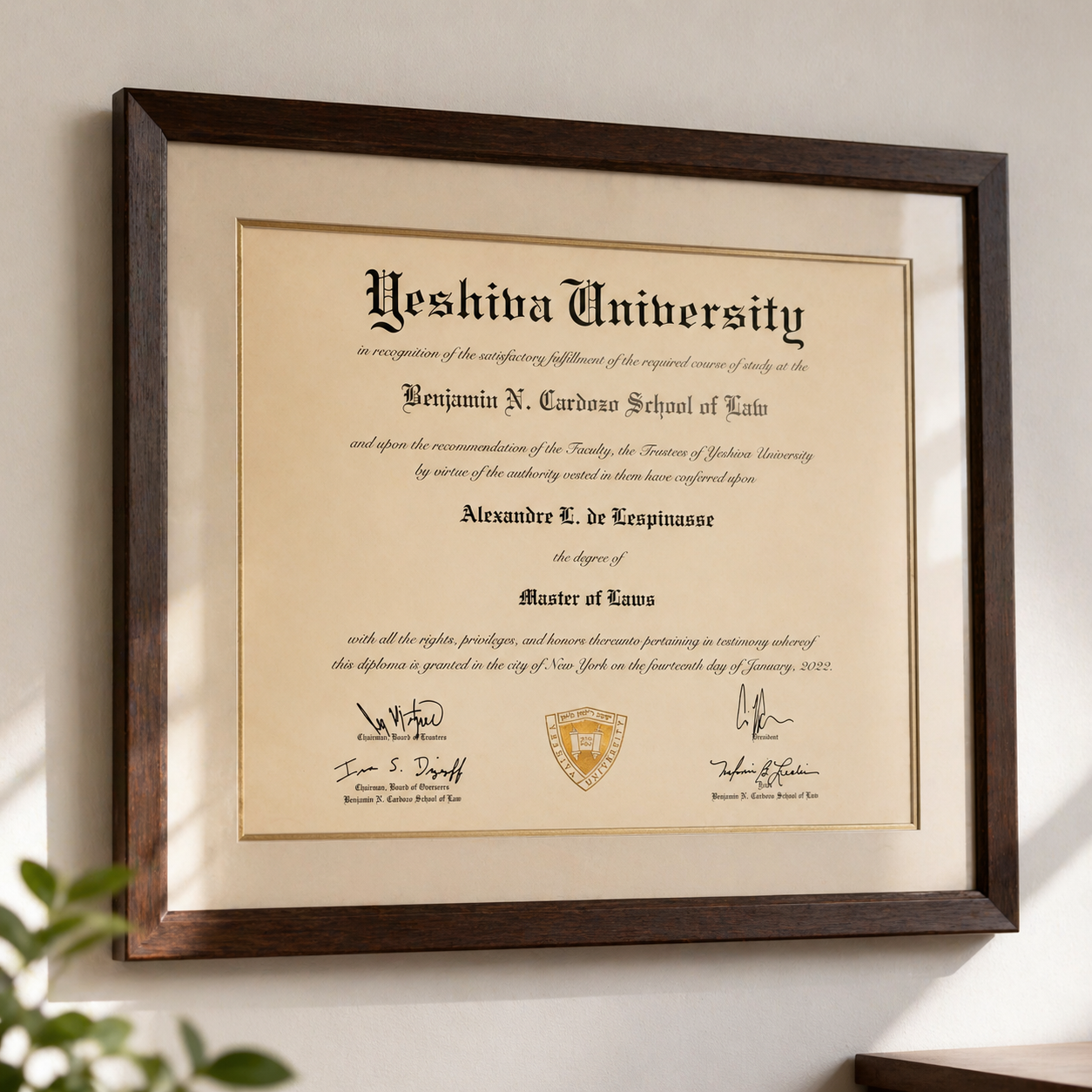 Diploma from Yeshiva University for Alexandre L. de Lespinasse, Master of Laws, signed by university officials, in a wooden frame on a wall.