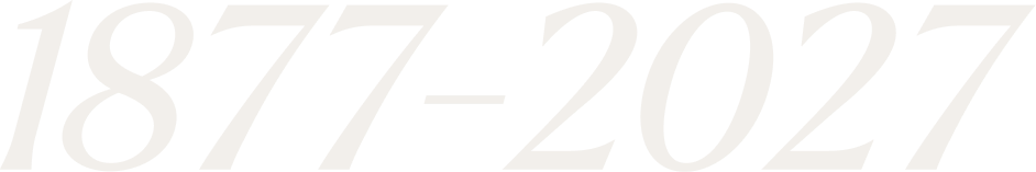 Image displaying the years 1877 and 2027 in large, white text representing the 150 years of legacy of de Lespinasse lawyers in Haiti