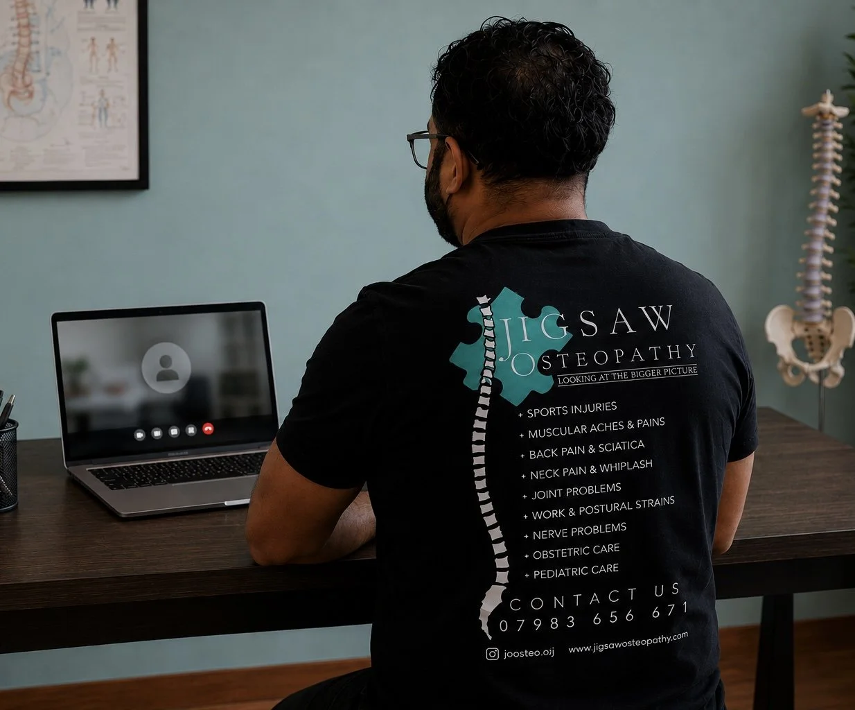 An Osteopath or Physiotherapist doing a virtual consultation in a clinic, in Hayes, West London