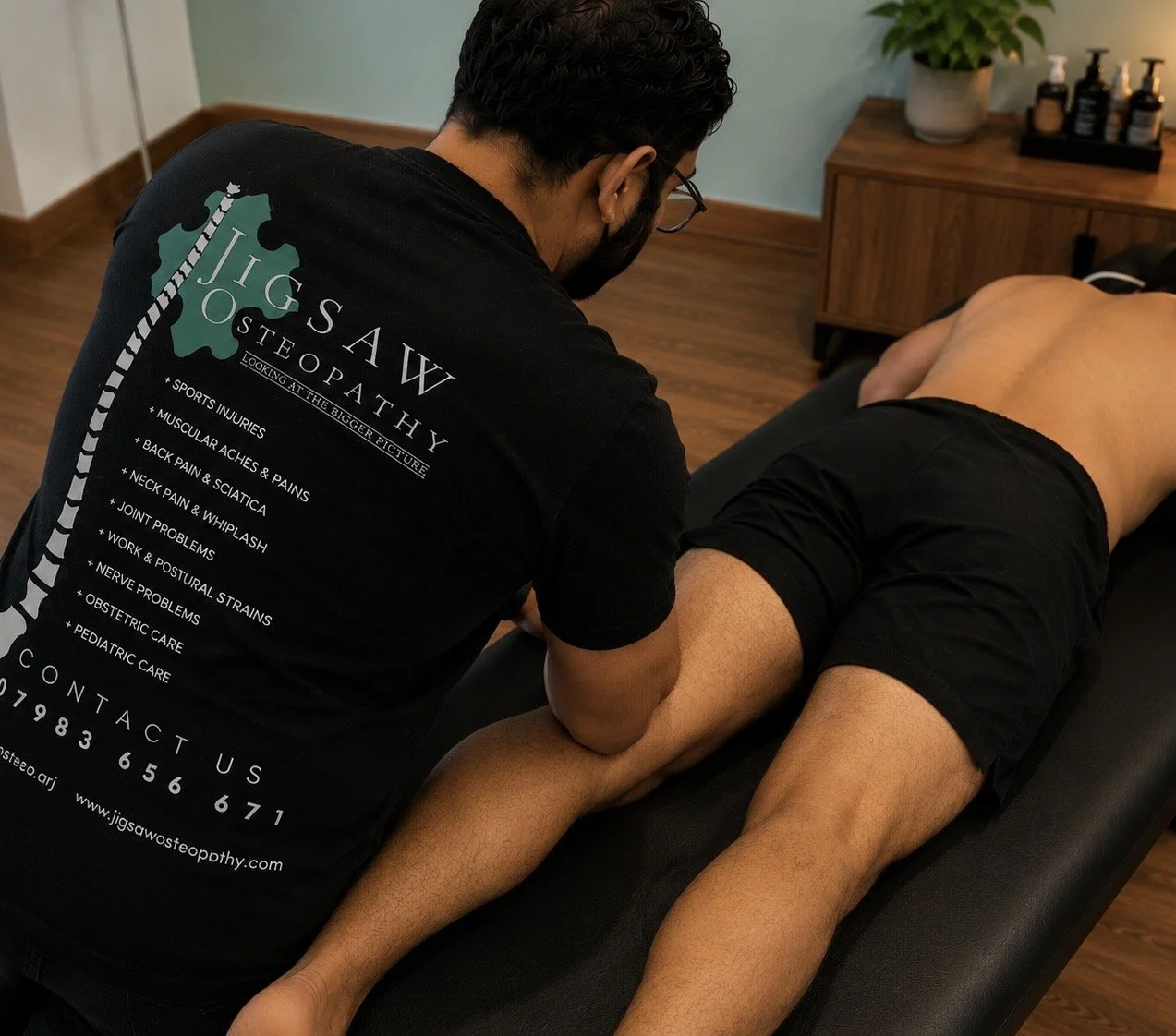 Sports massage to the hamstring of a man in clinic, in Hayes, West London