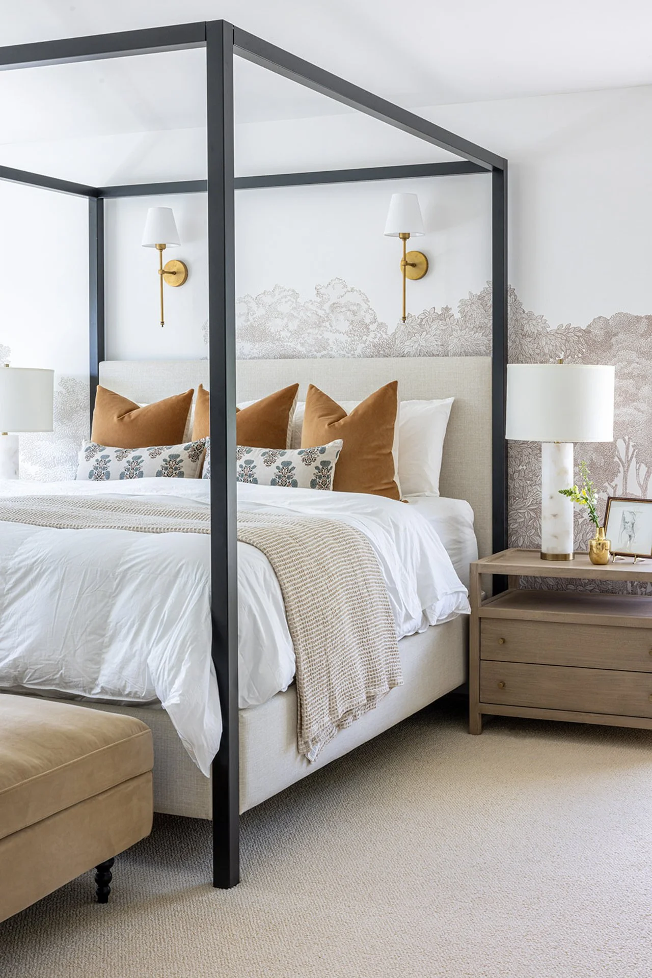bedroom photo with accent wallpaper and gold throw pillows under a canopy bed