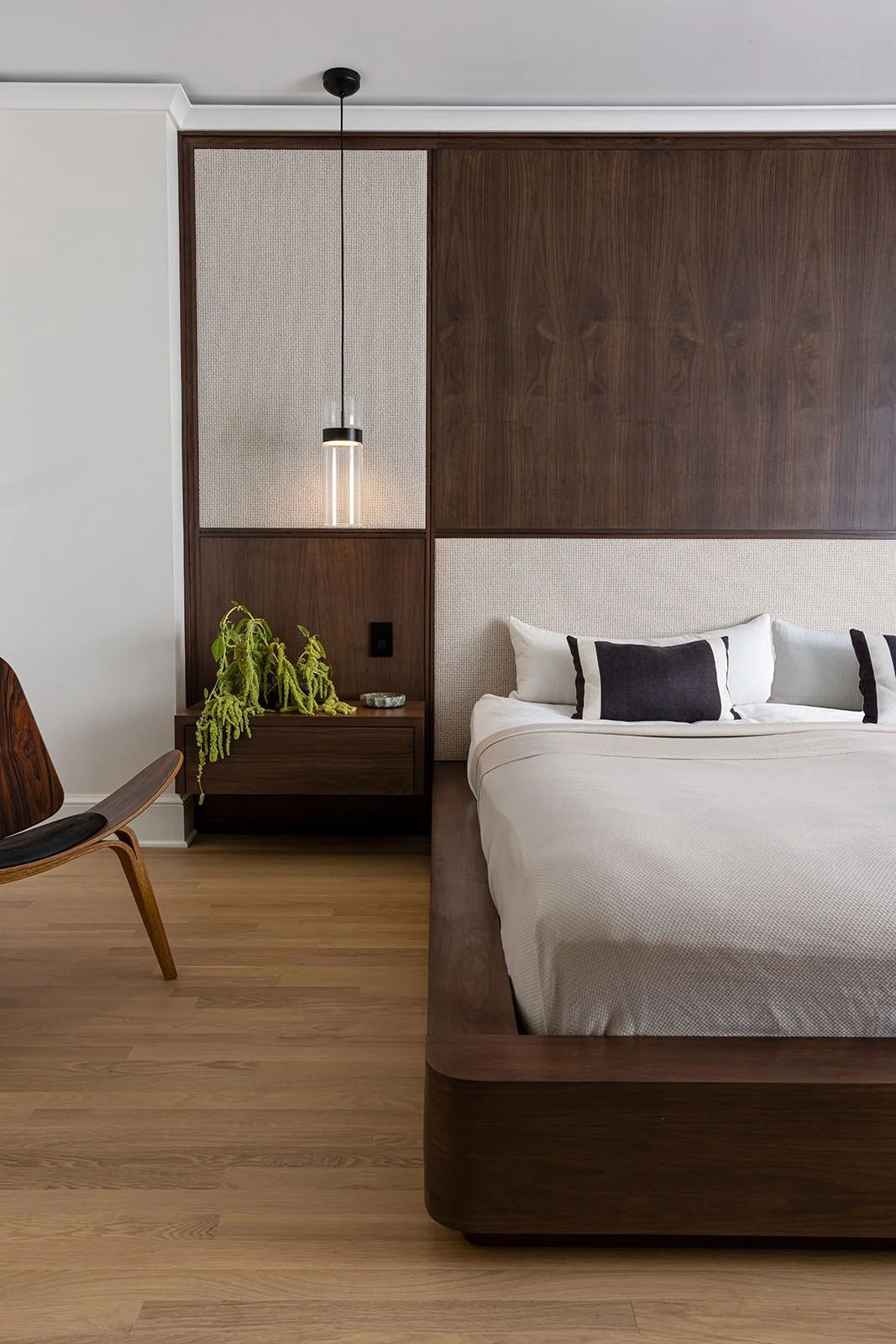 modern bedroom with dark wood accents paired back to clean lines