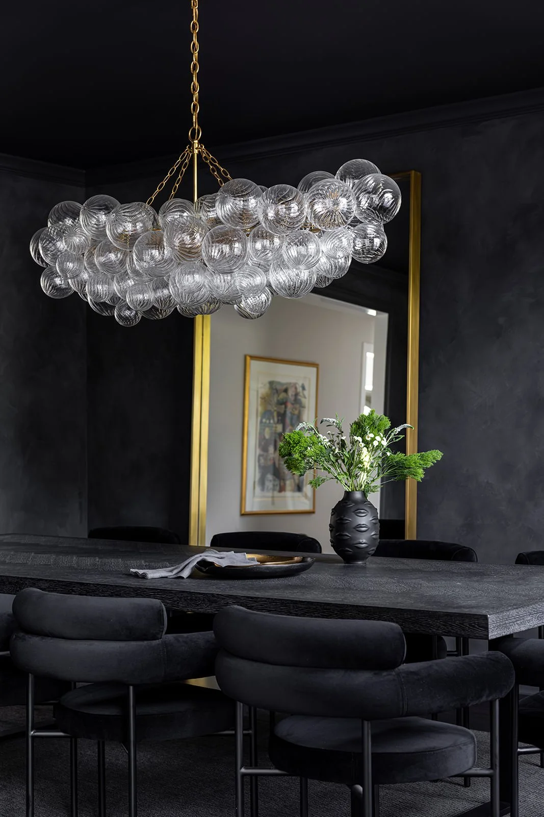 dark black room with high impact light and thoughtfully curated artwork