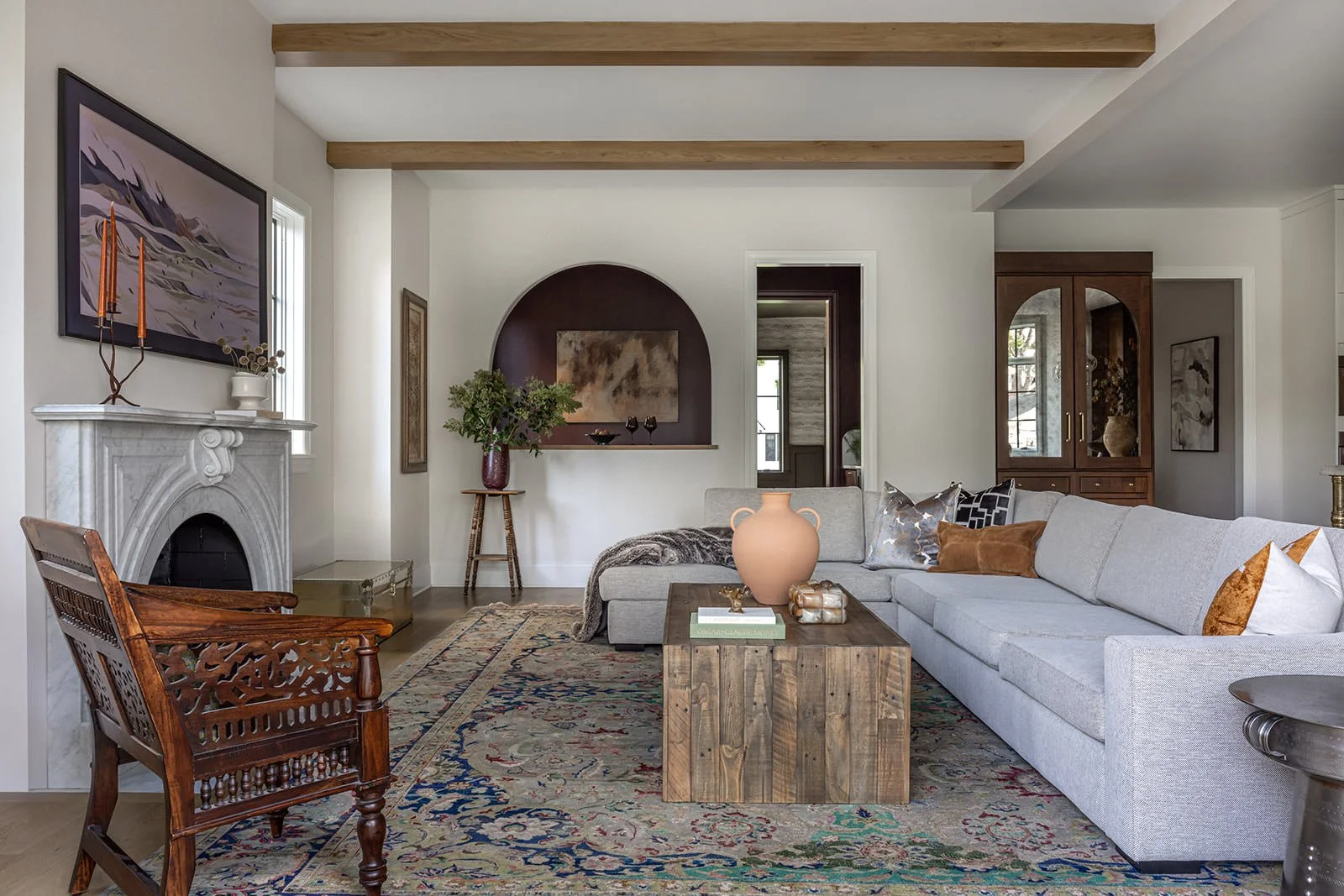 layered living space with fireplace, sofa, chair and coffee table