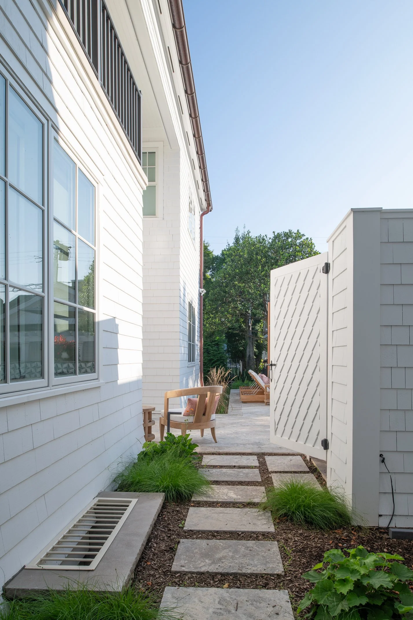 Award-winning side yard transformation with designer stepping stone walkway, outdoor shower, lush border plantings, elegant white gate, NJ luxury landscape design