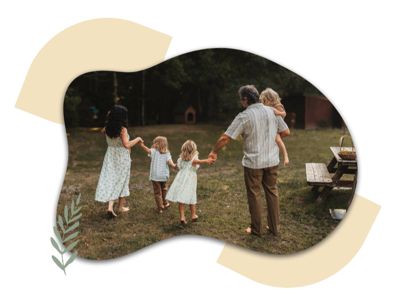 Parents holding hands walking across a grassy yard at dawn, part of the Learning Circles homeschool community.