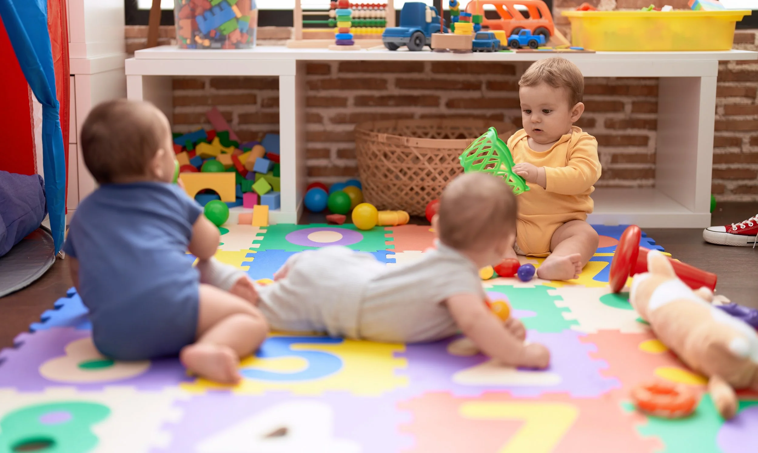 group-toddlers-playing-with-toys-crawling-floor-kindergarten.jpg
