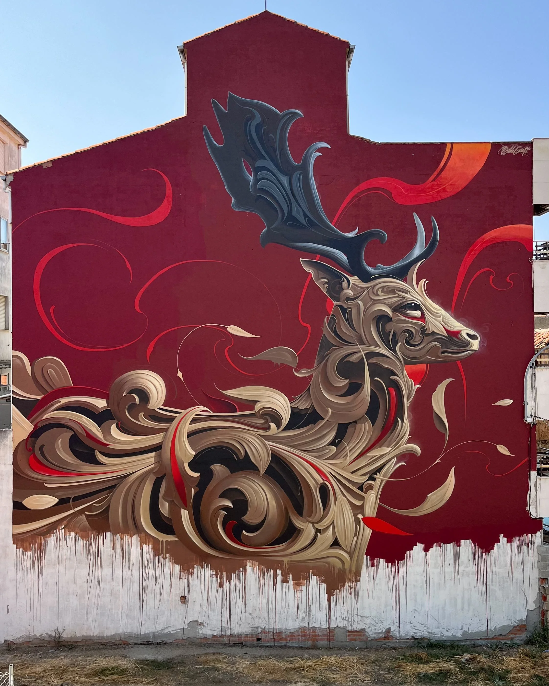 Monumental mural titled "Ornamental Deer" by Bublegum (Tirso Paz) in La Bañeza, Spain. This large-scale public art piece combines the artist's signature Ornamental Style with wild nature imagery and classical typography, contributing to urban beautif
