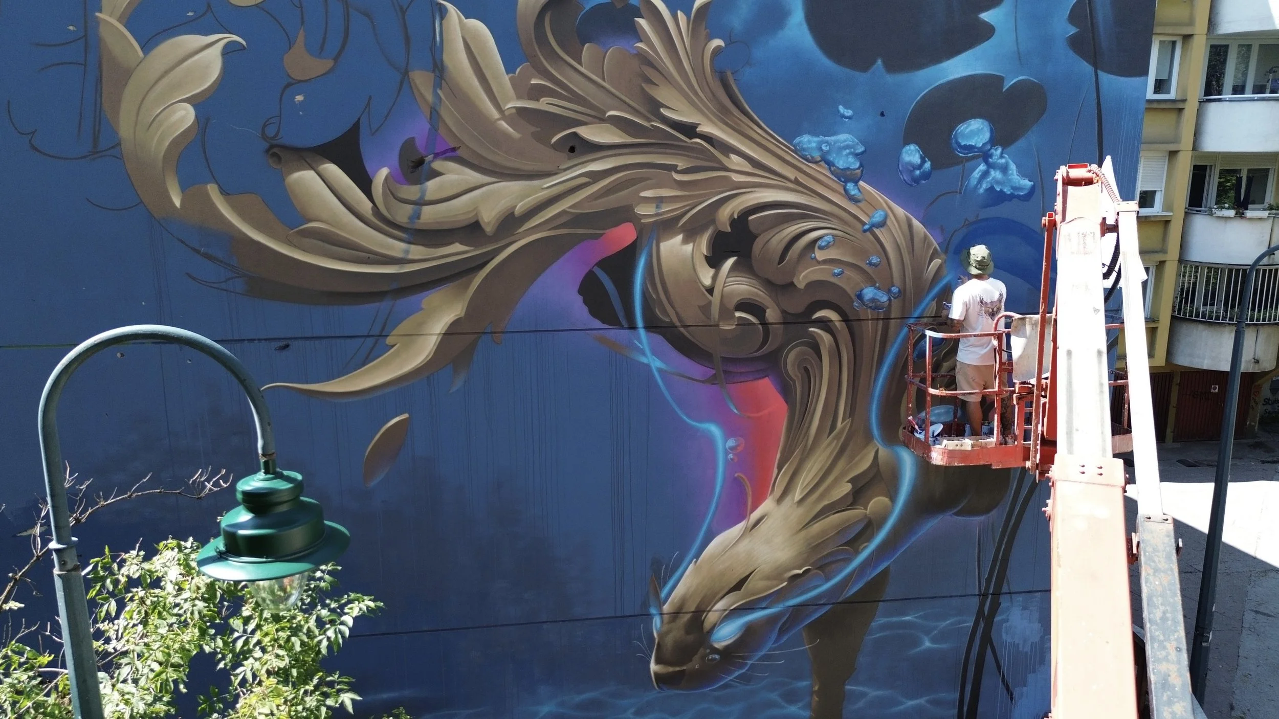 Artist Bublegum (Tirso Paz) creating a large-scale mural. Professional urban artist and creator of the Ornamental Style, specialized in international public art commissions and contemporary fine art.