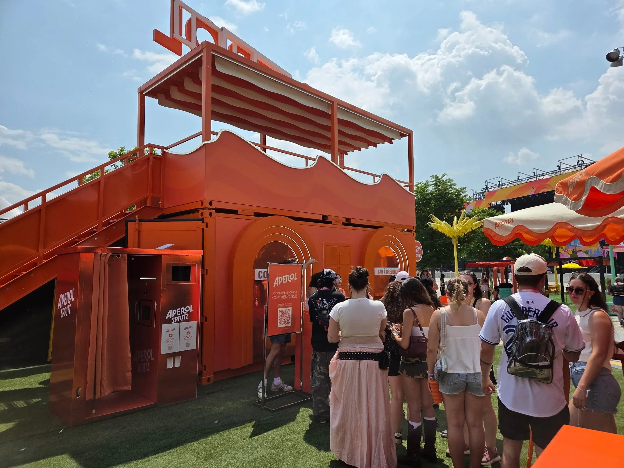Guests receiving instant prints from an enclosed photo booth.