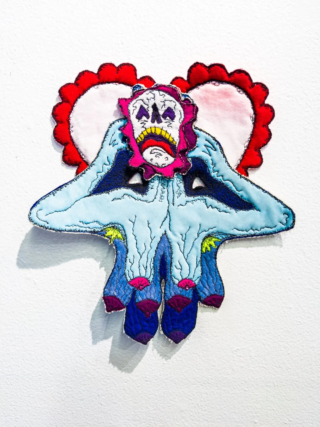 "Mask V. 4." Canvas, thread, acrylic paint, felt, metal wire. 21" H X 18" W. 2020. 