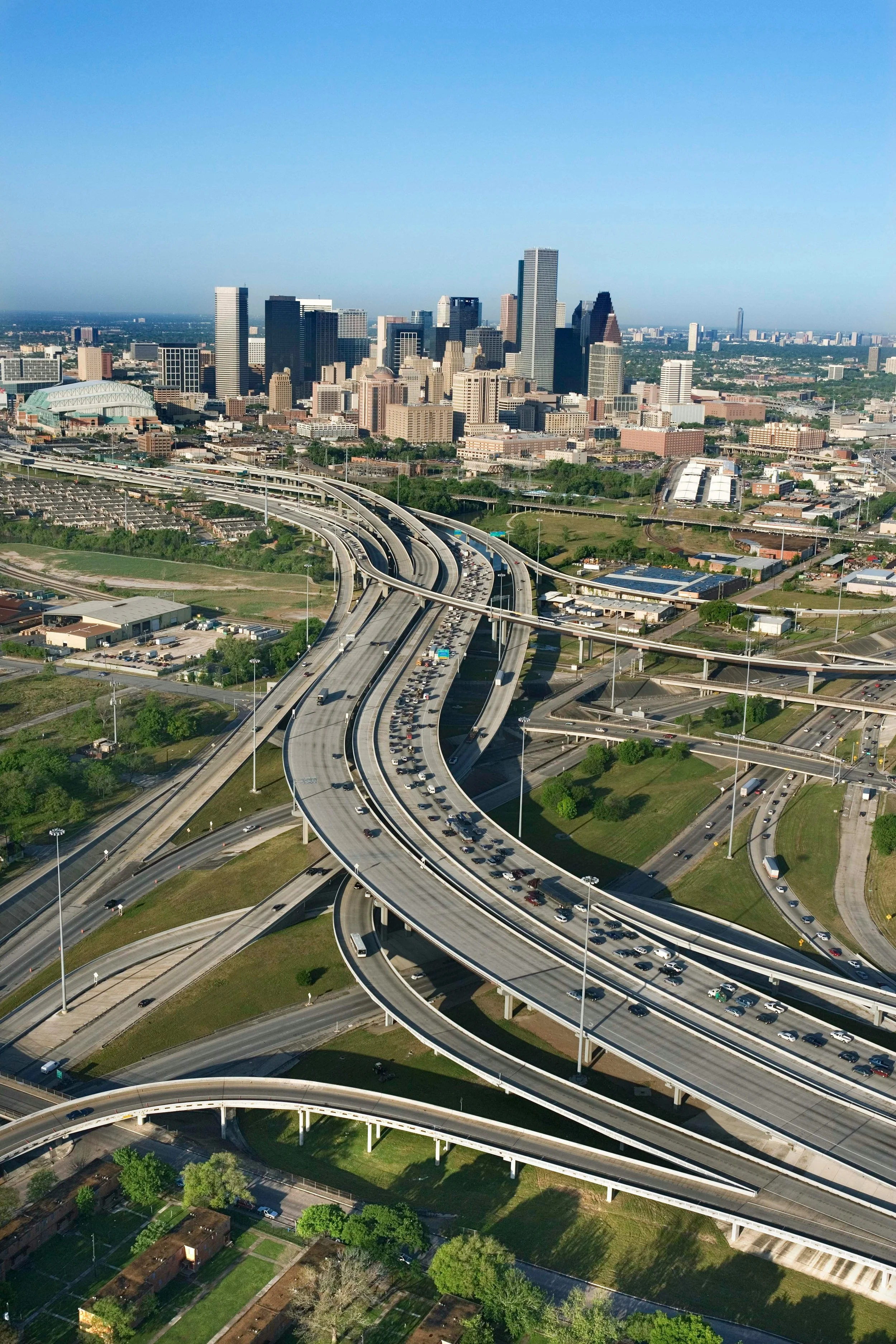 Aerial view of the Houston, Texas skyline with highways and greenery.