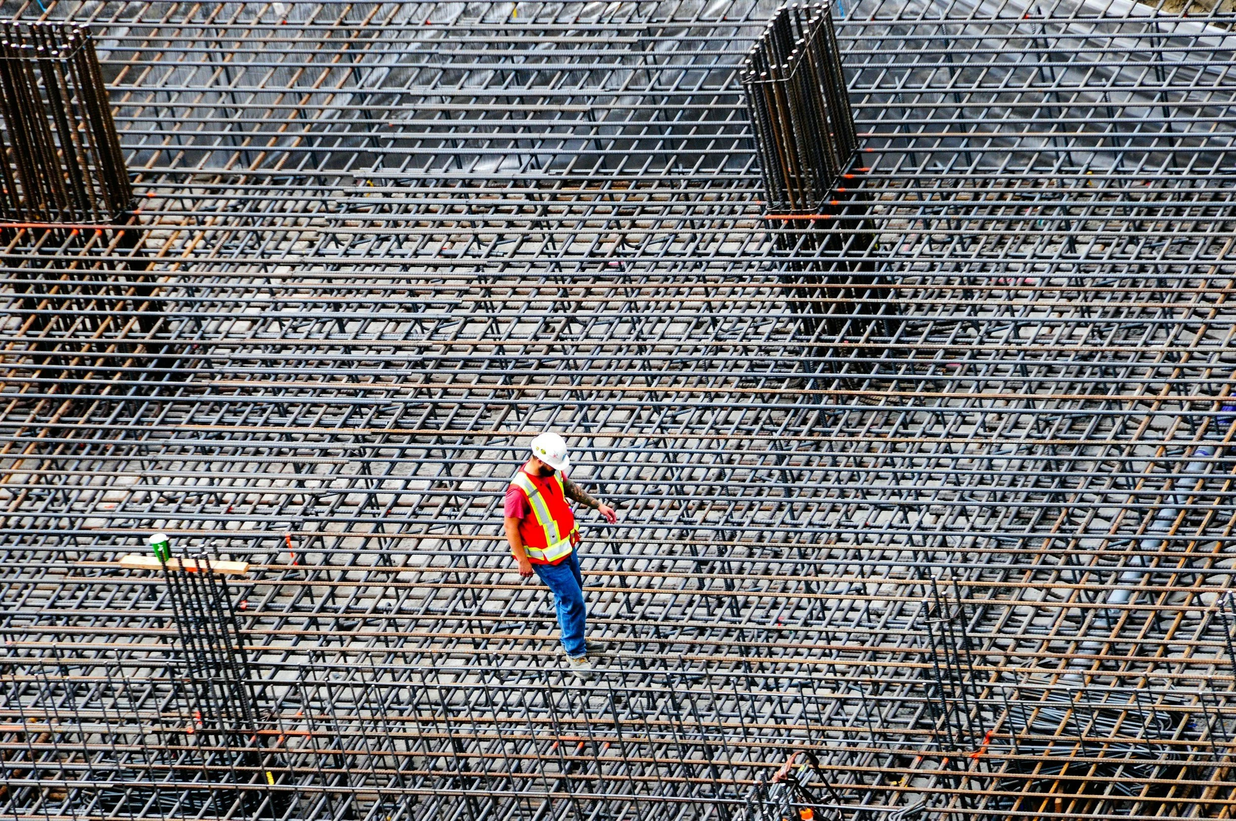 Construction professional working on reinforcement at a project site