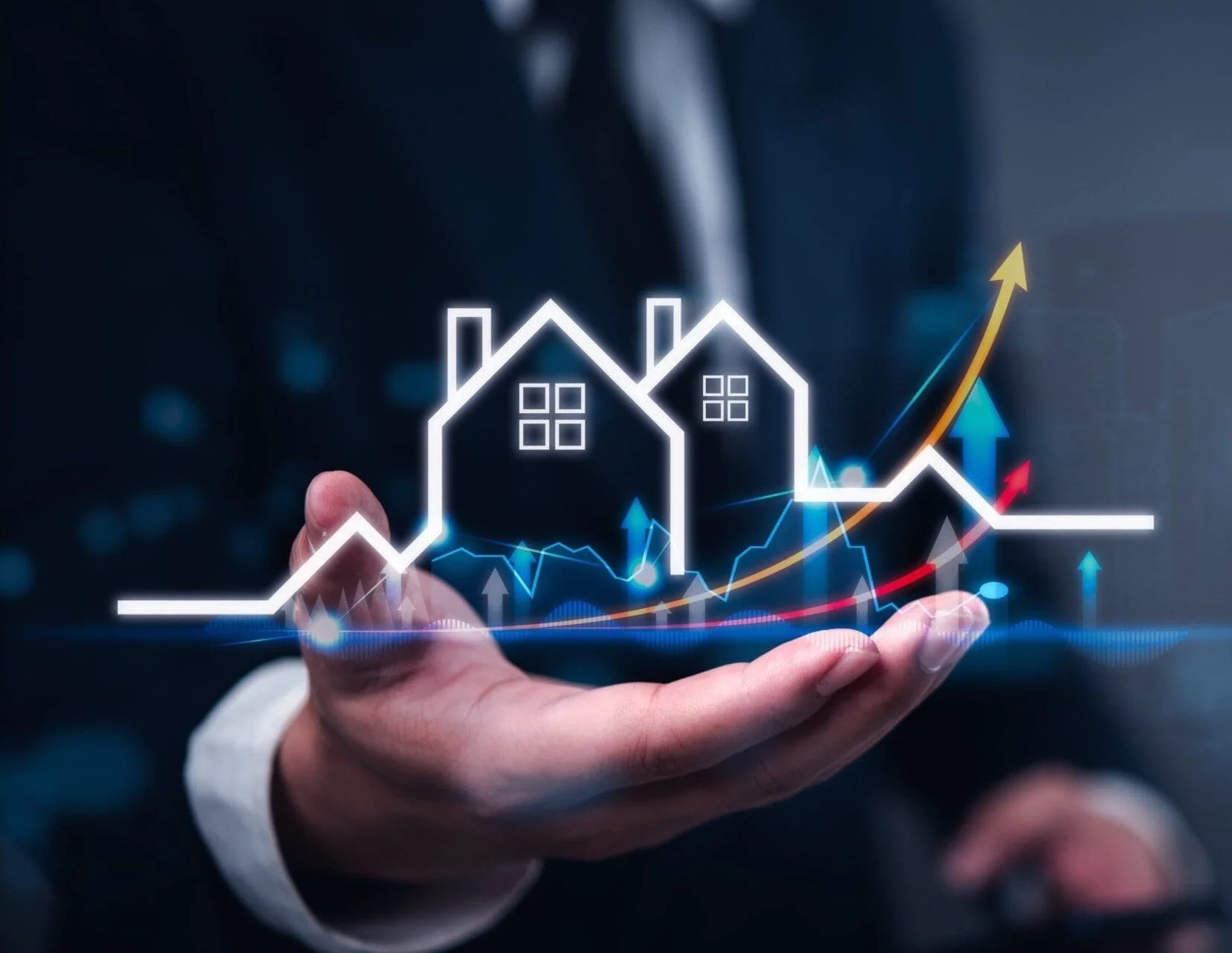 Hand holding a digital graphic of a house with moving upward trending lines and arrows, symbolizing real estate market growth.