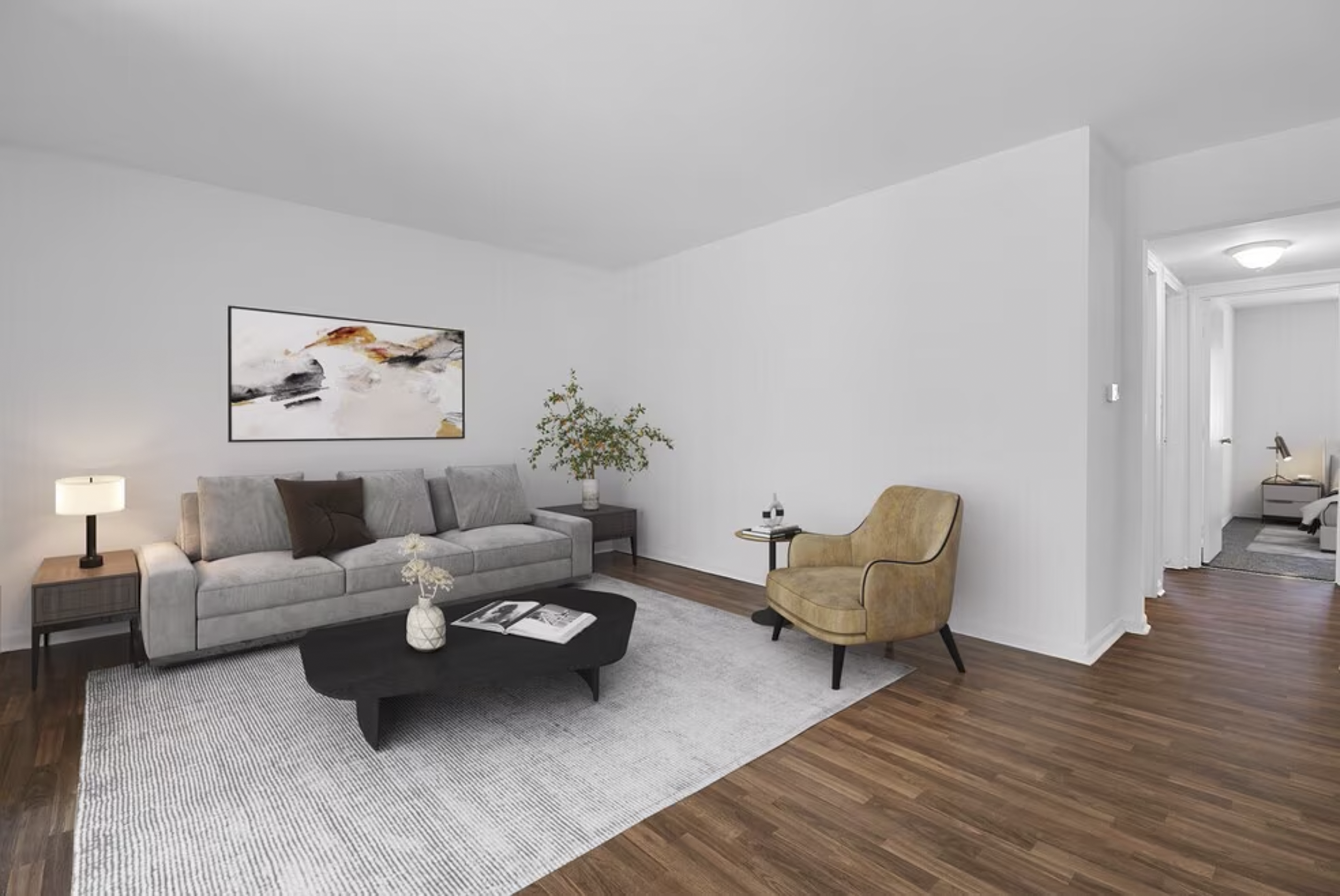 Living room featuring a light gray sofa with pillows, a black coffee table with books, a yellow armchair, a side table with a bottle of wine and glasses, a table lamp, a potted plant, and modern artwork on the wall, with hardwood floors and white wal